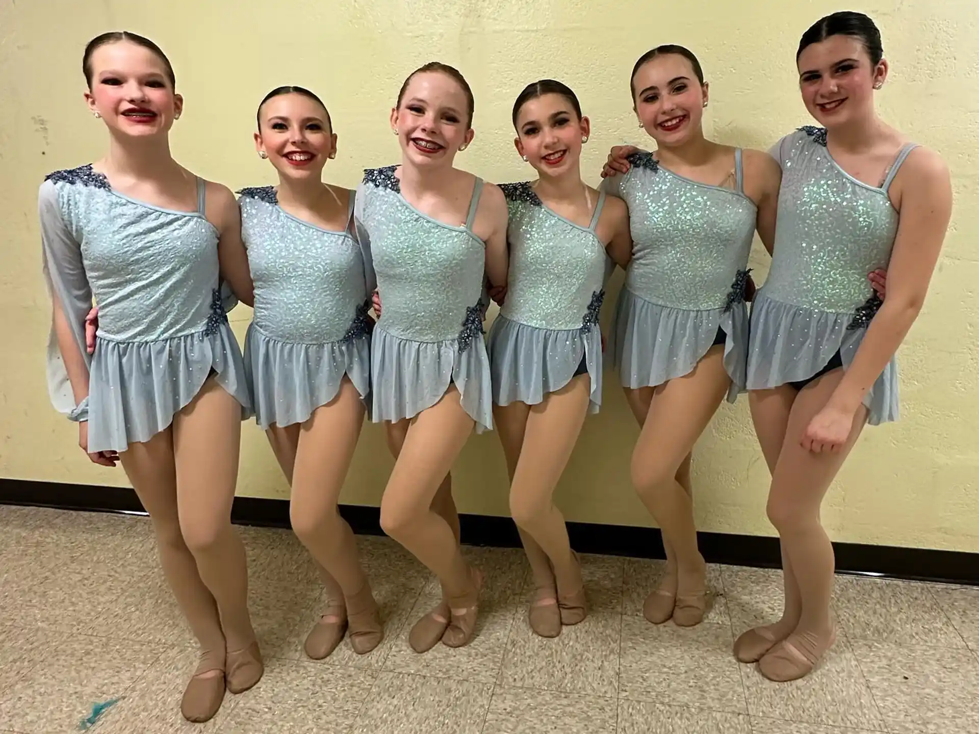 a group of women in matching outfits