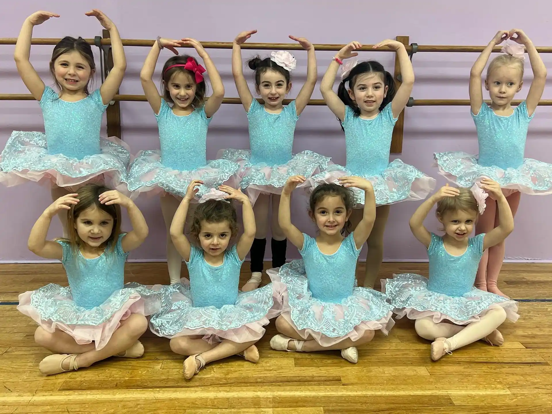 a group of girls in blue dresses