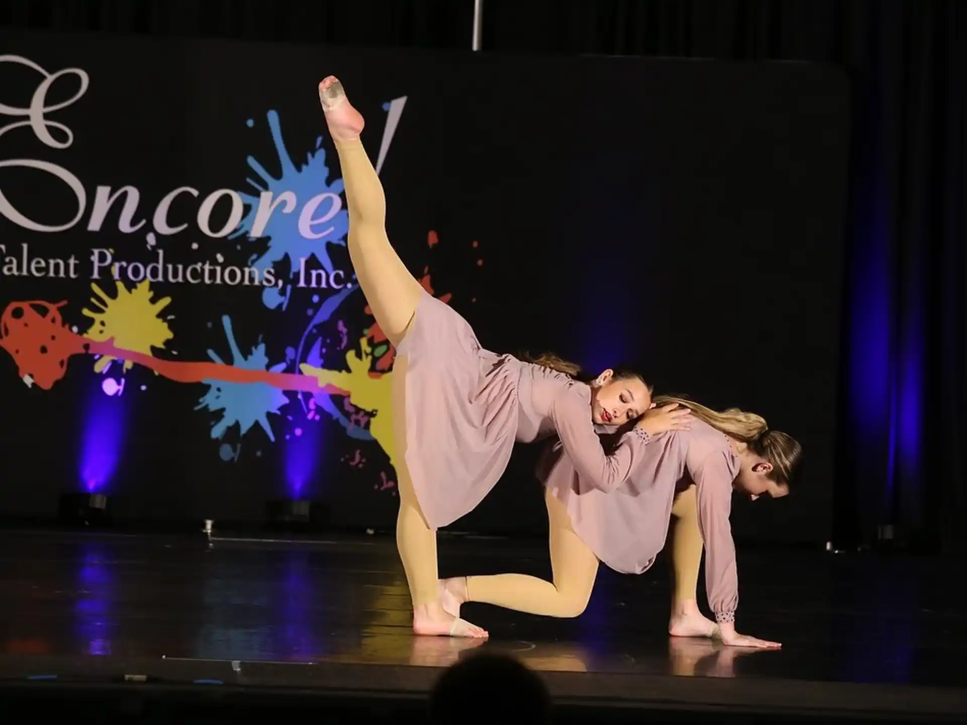 a couple of women dancing on a stage