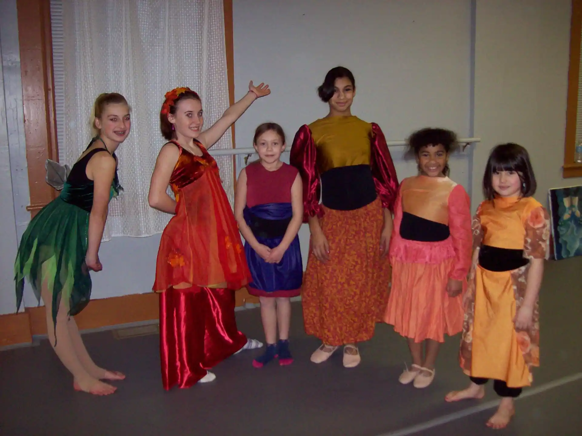 a group of girls in dresses