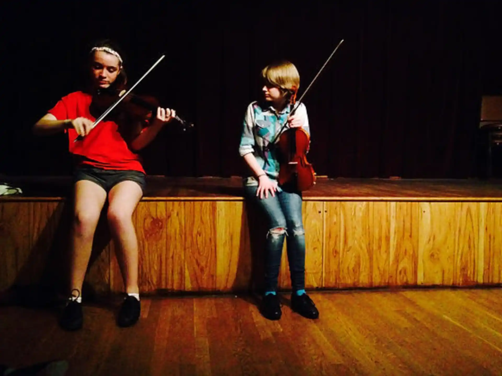 a person and a boy playing violin