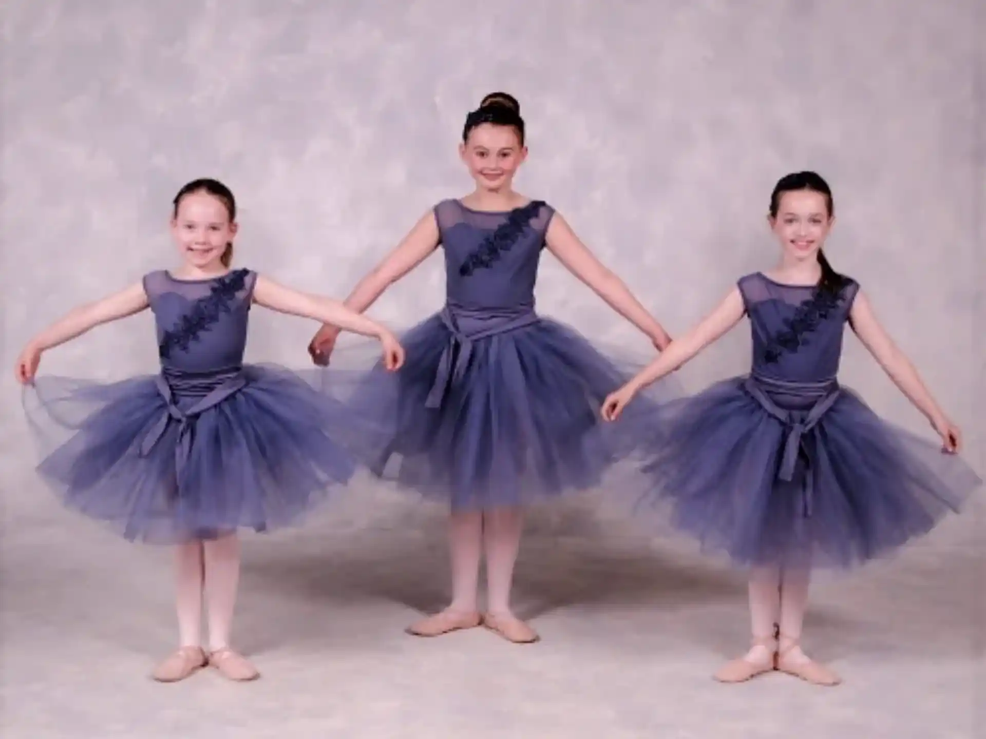 a group of girls in dresses