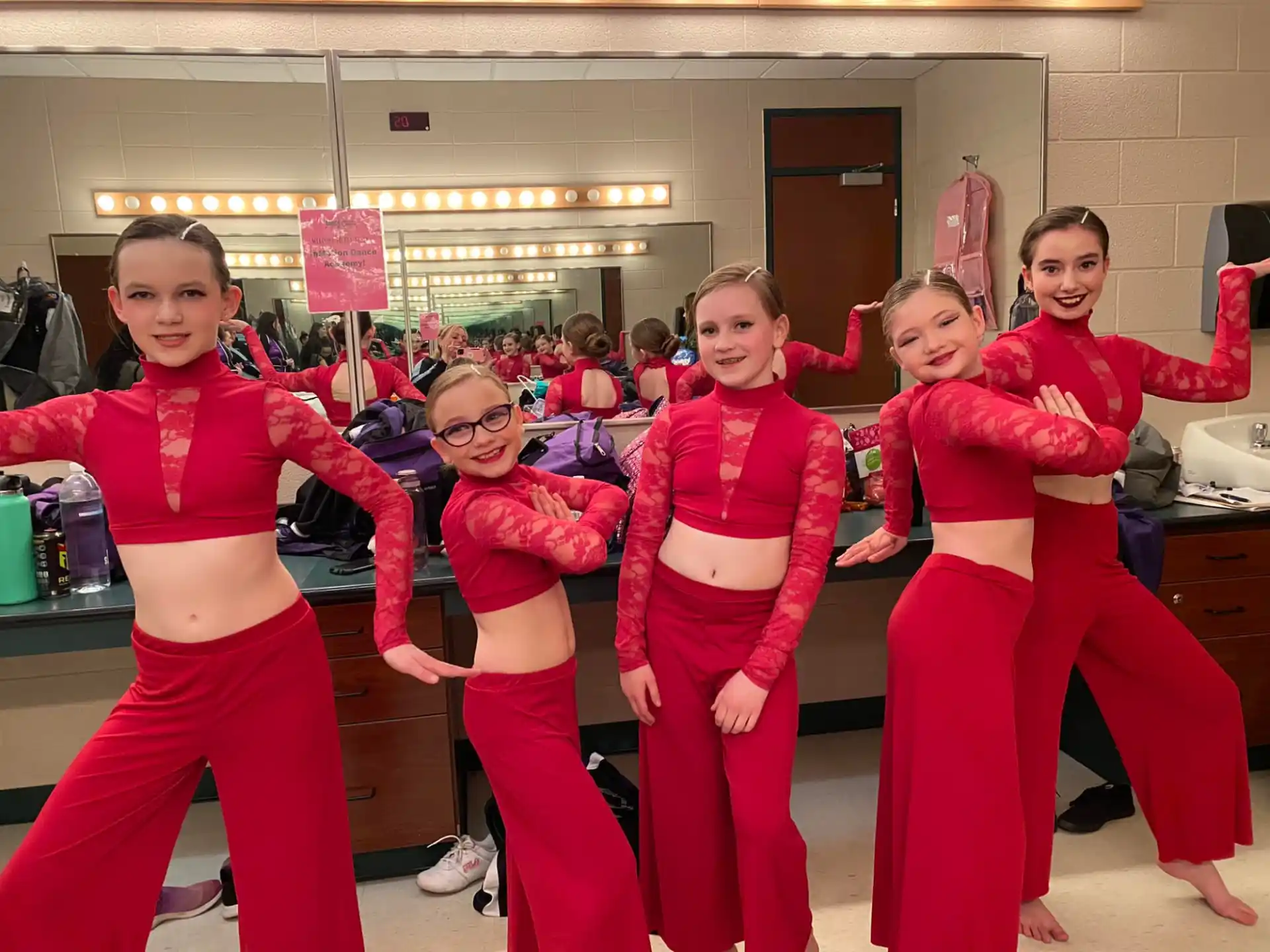 a group of girls in red pants