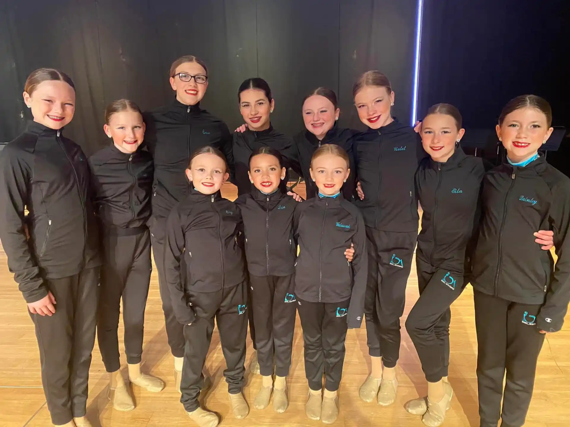 a group of children in black jackets