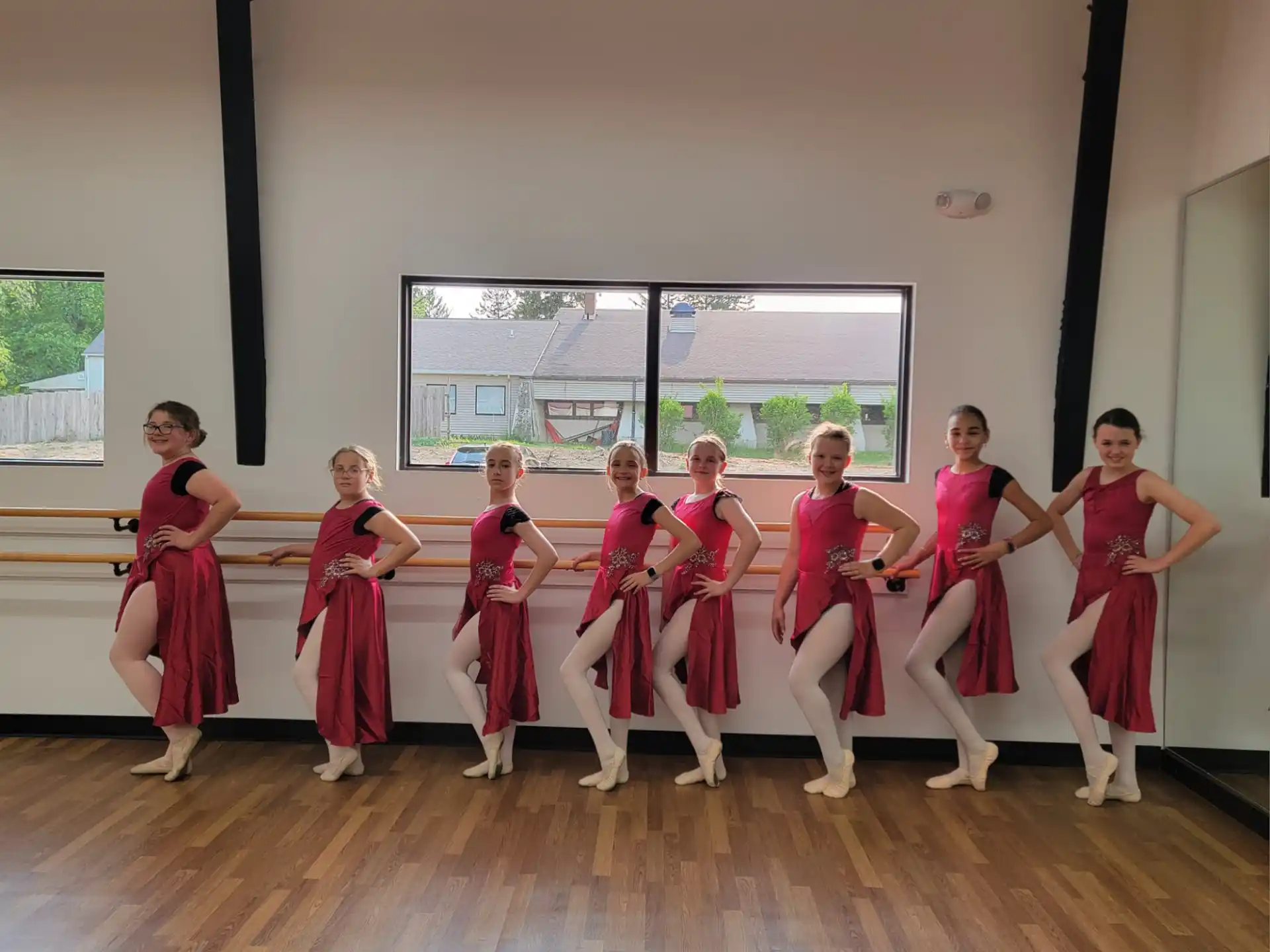 a group of women in red dresses
