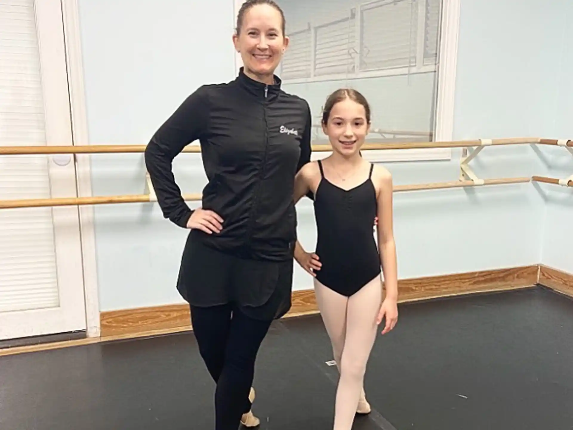 a woman and a girl posing for a picture