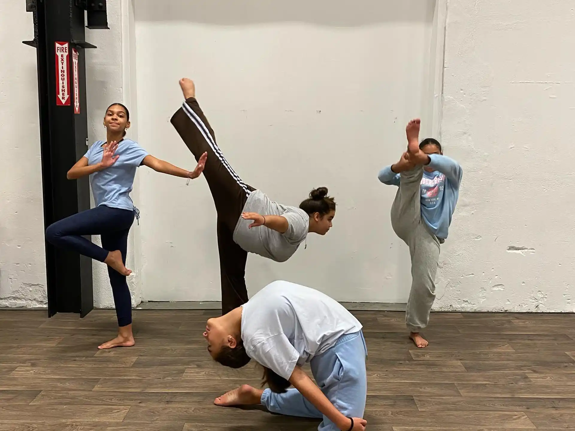 a group of people doing a handstand on a sidewalk