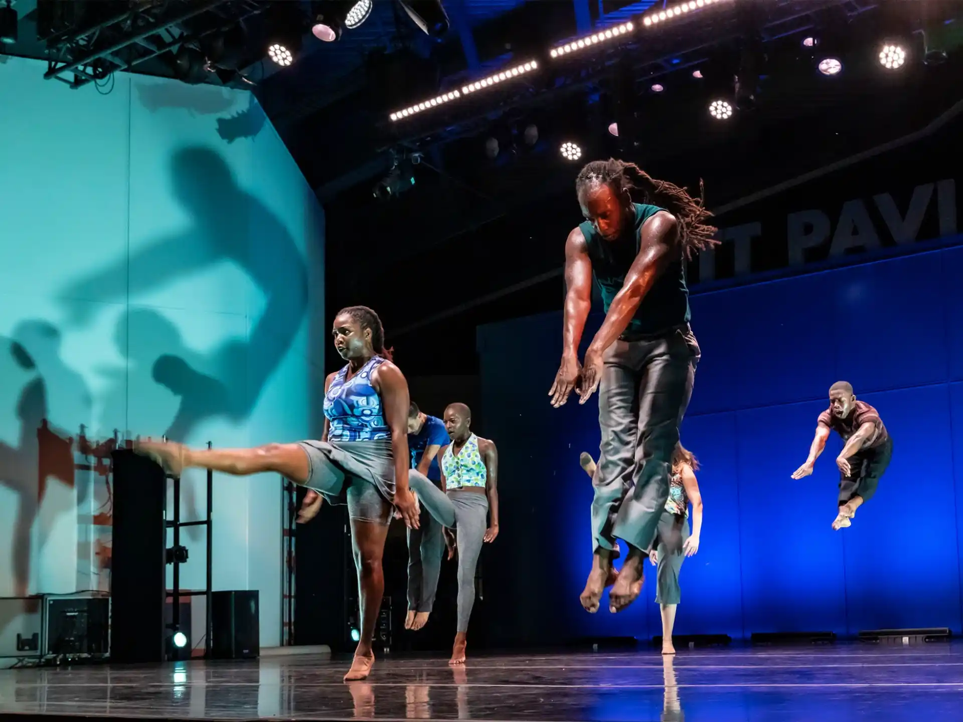 a group of people dancing on a stage