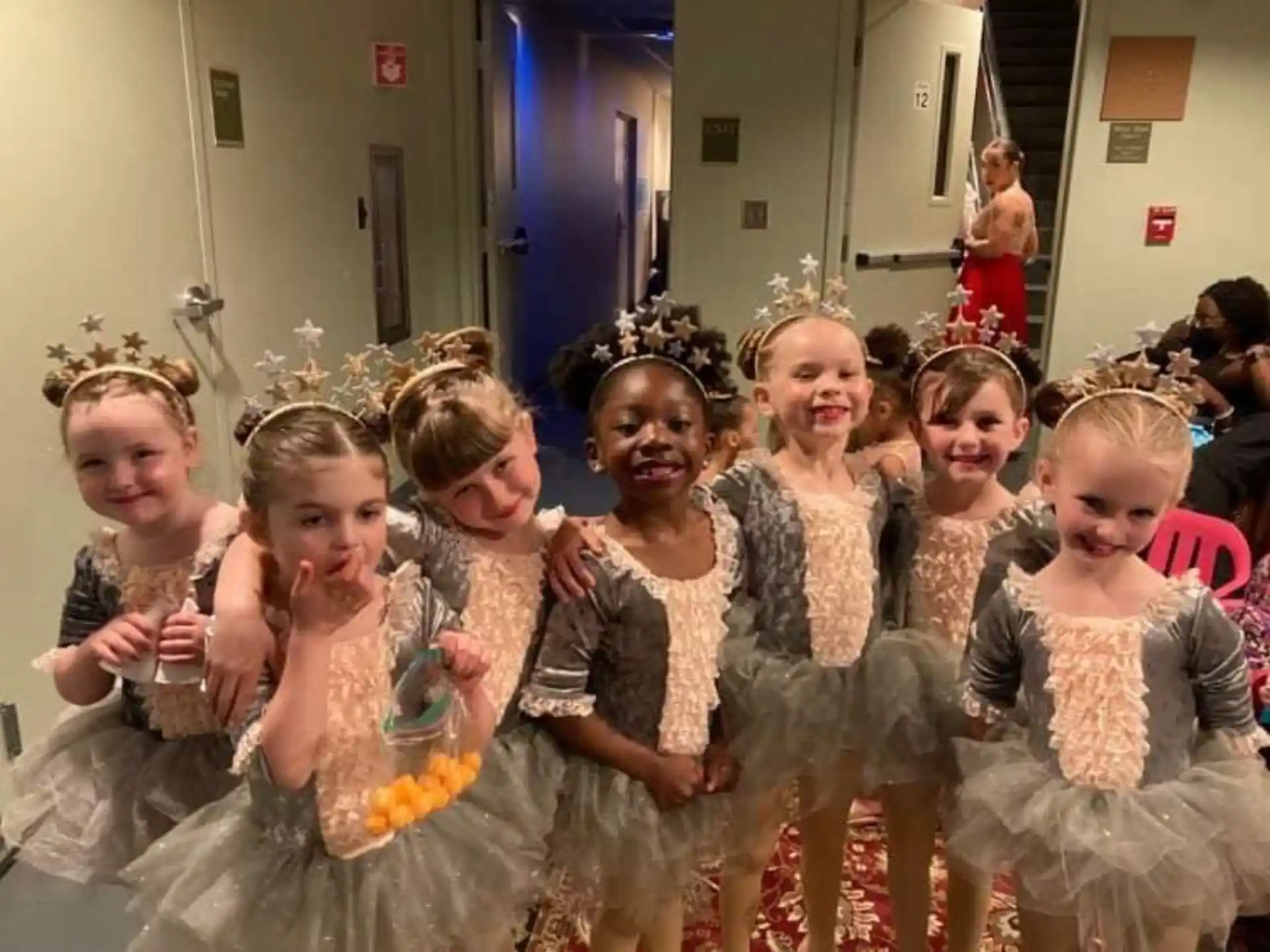 a group of girls in dresses