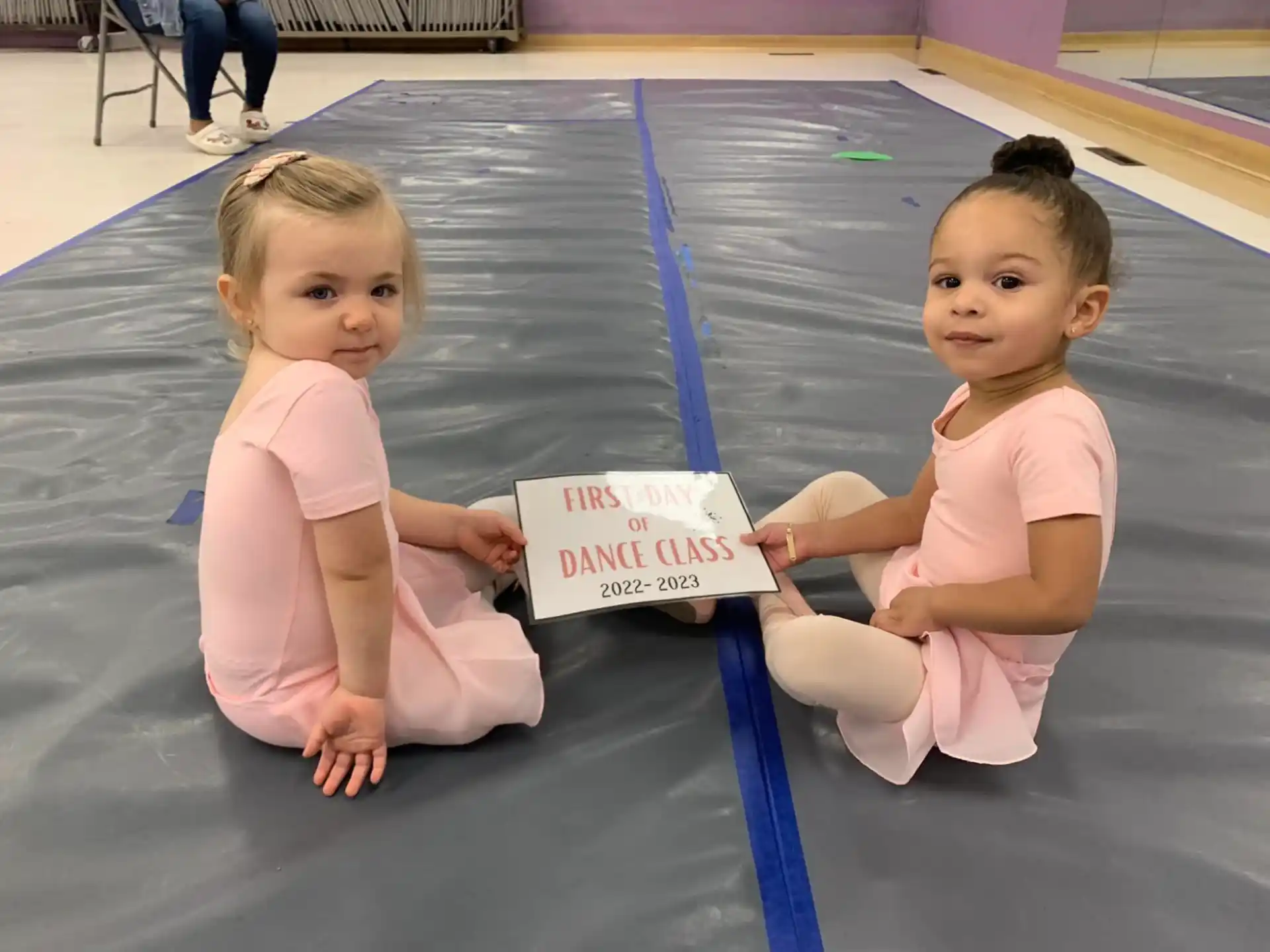 two babies sitting on the floor
