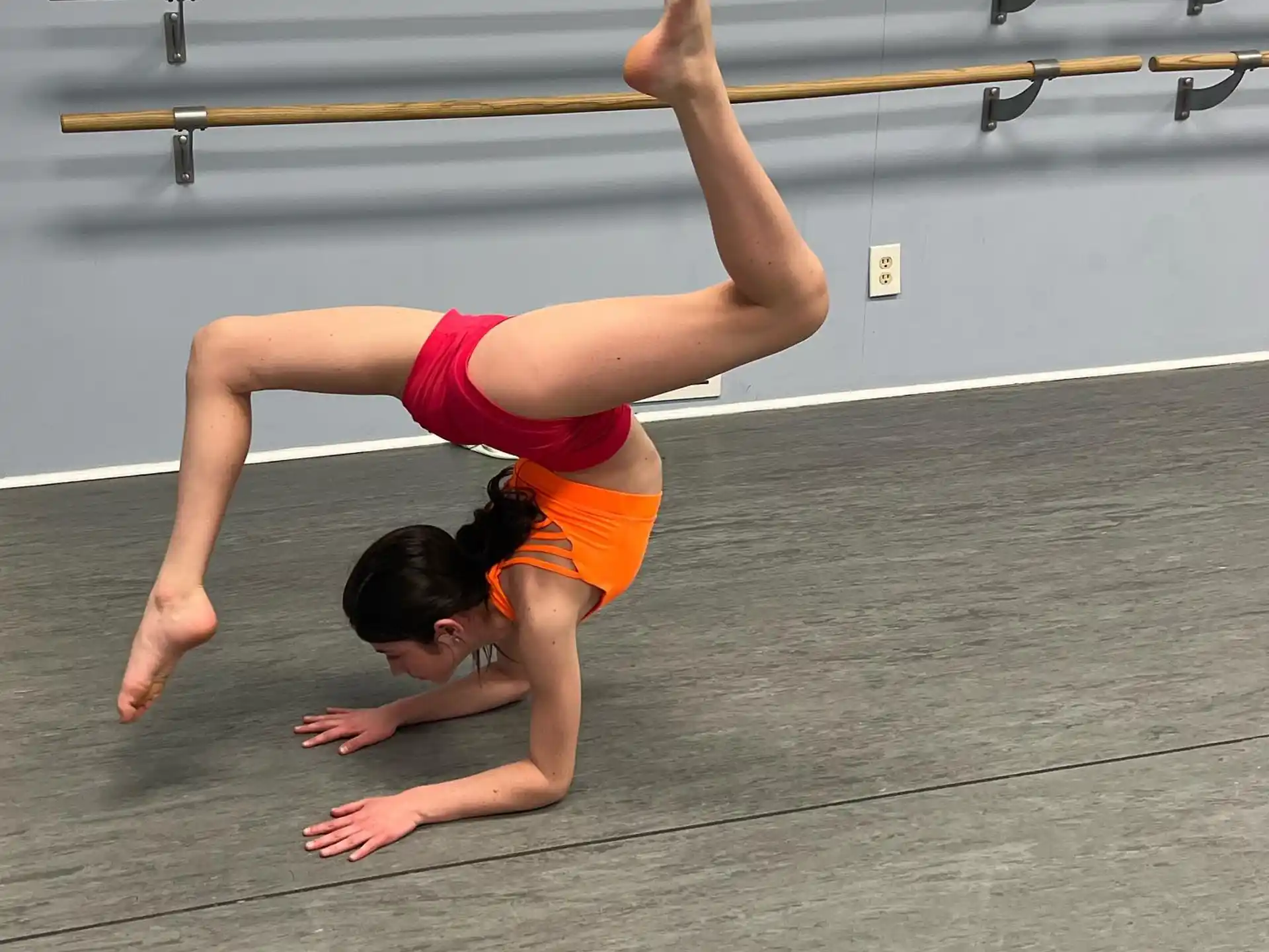 a person doing a handstand on a track