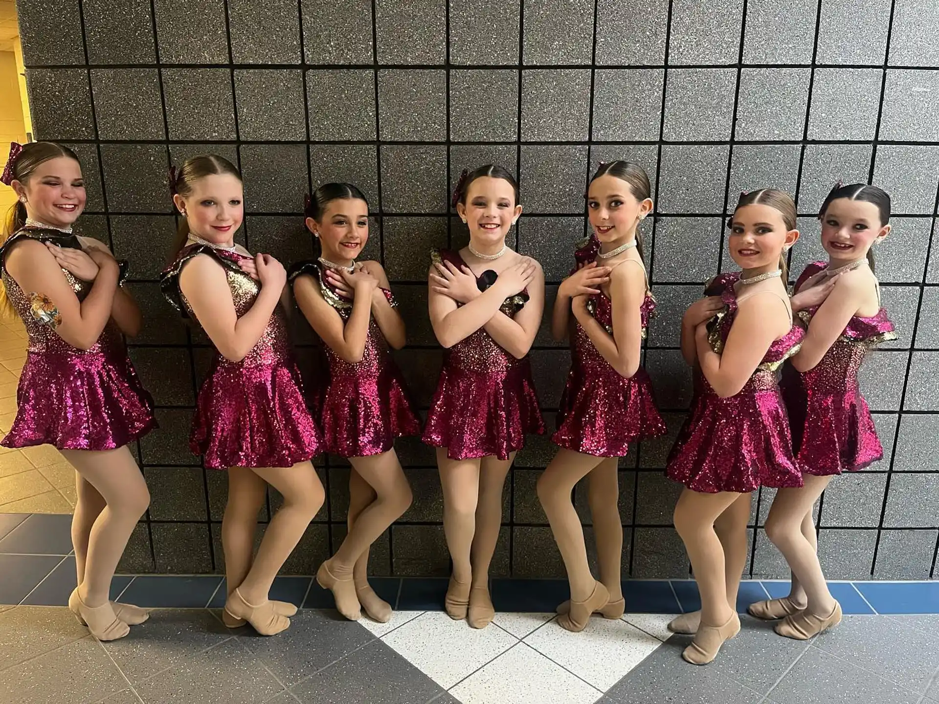 a group of girls in dresses
