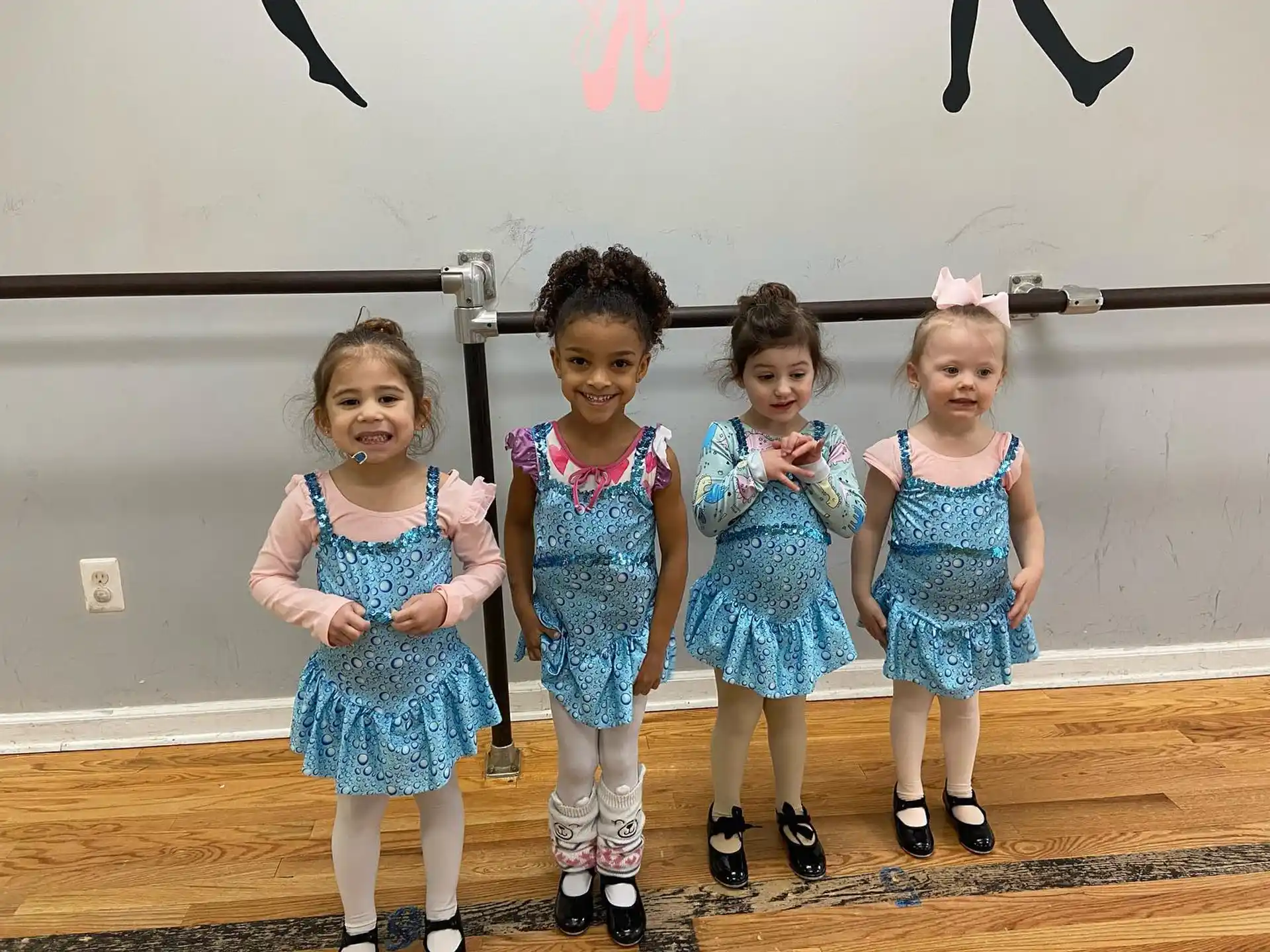 a group of girls in blue dresses