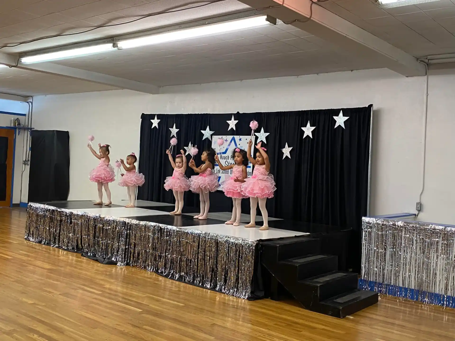 a group of girls performing on a stage