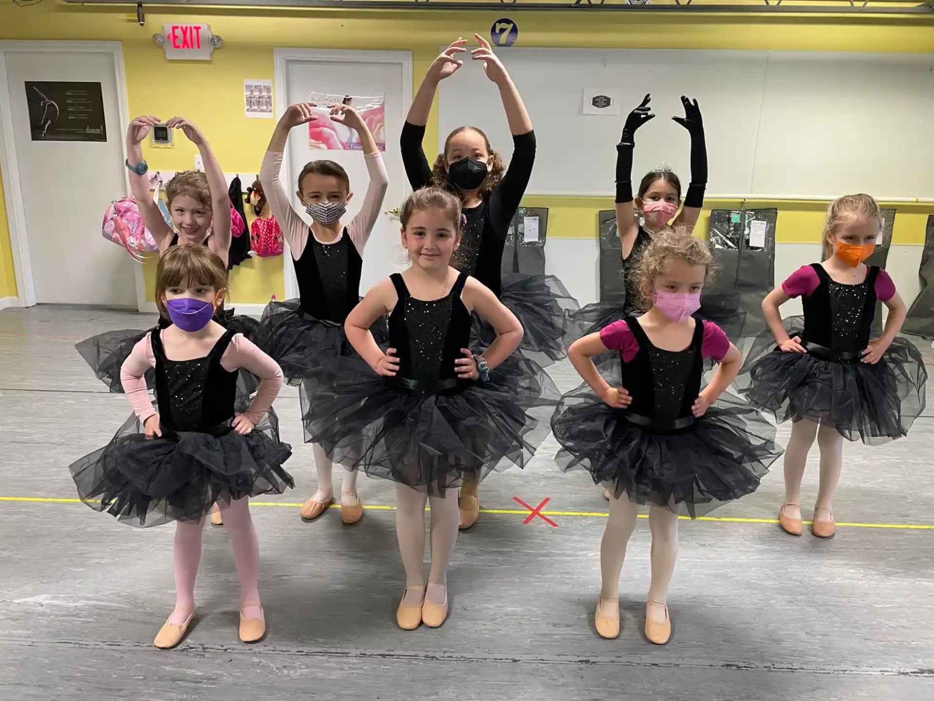 a group of girls in black dresses