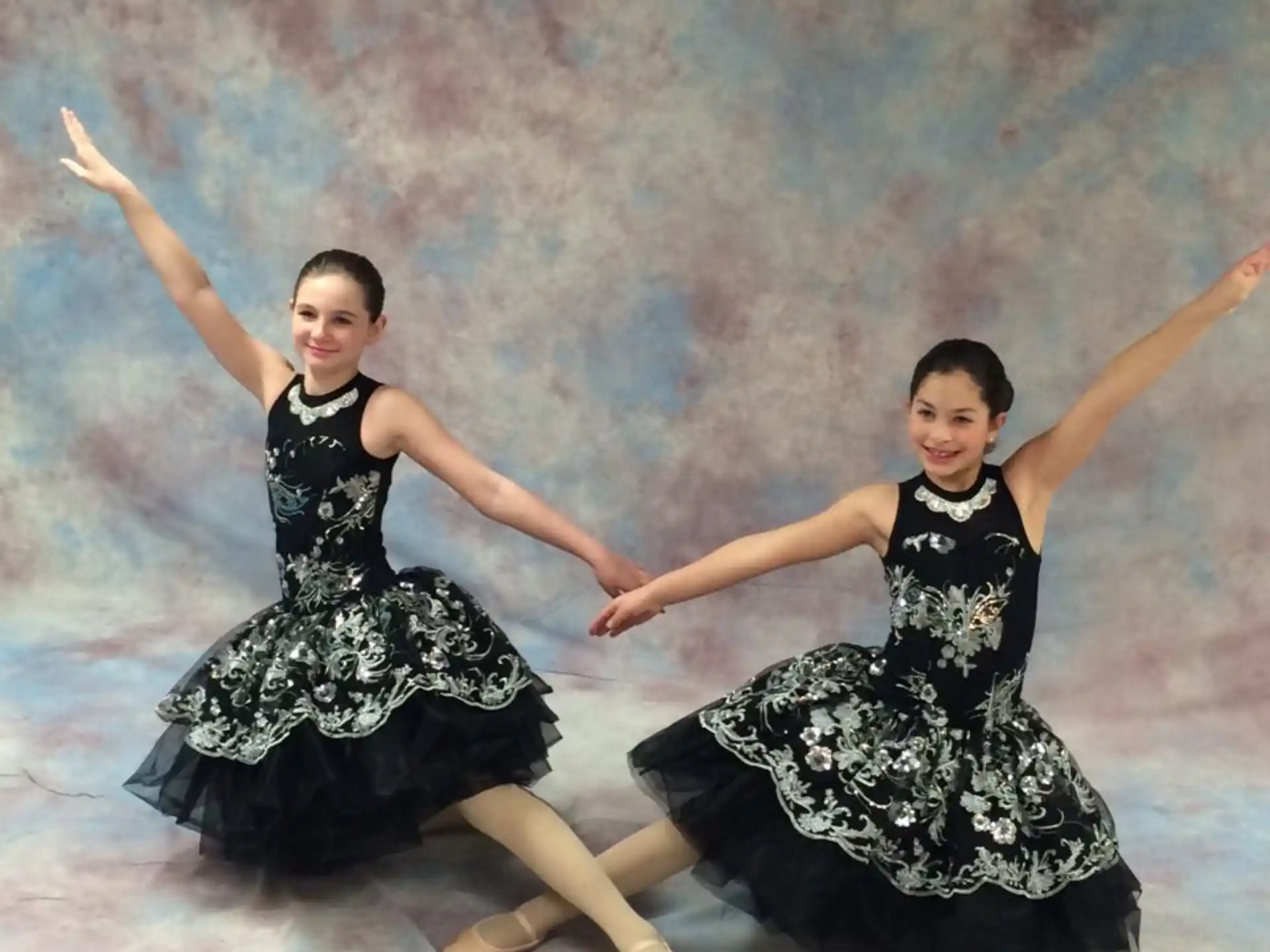 two women in black dresses