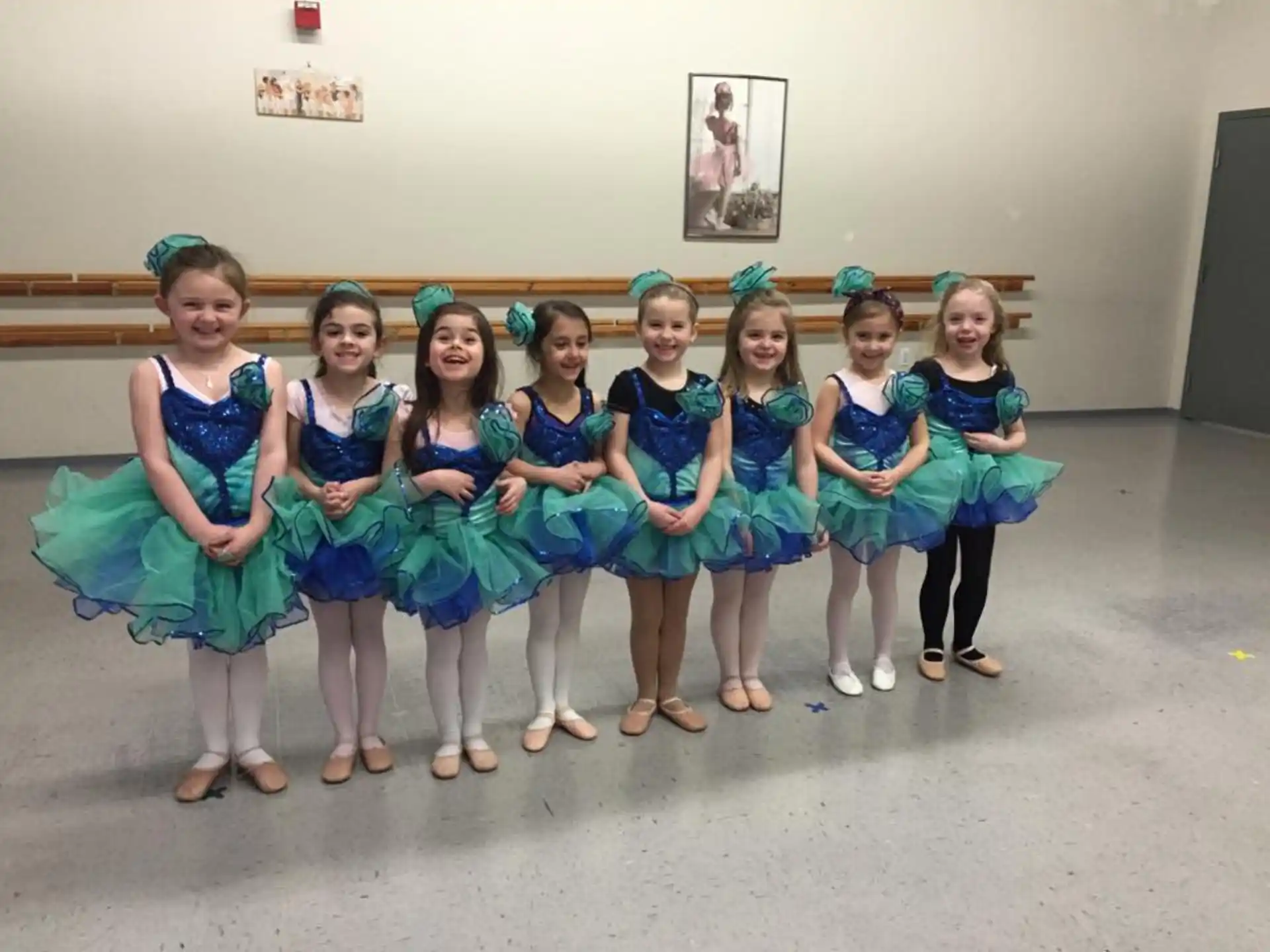a group of girls in blue dresses
