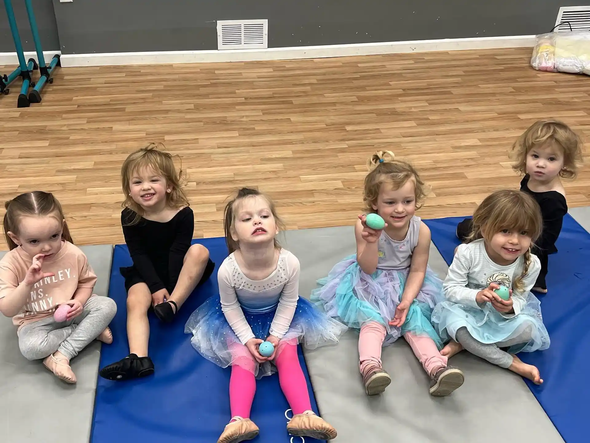a group of children sitting on a mat