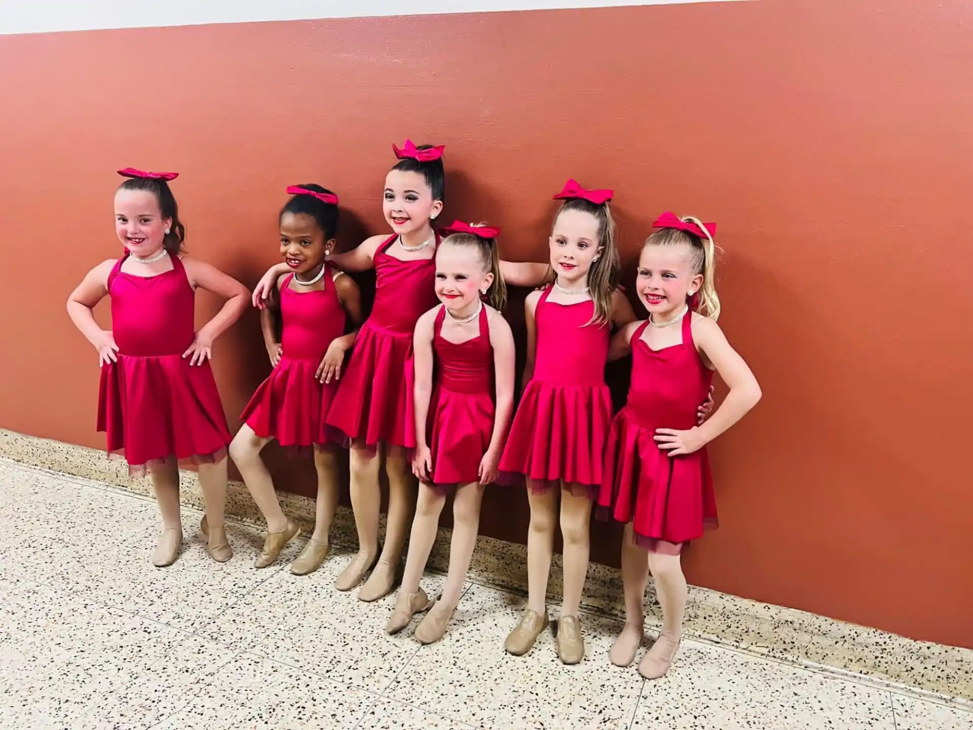 a group of girls in dresses