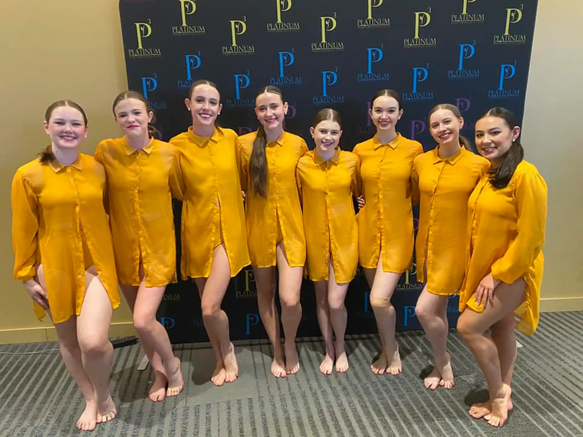 a group of girls in yellow uniforms