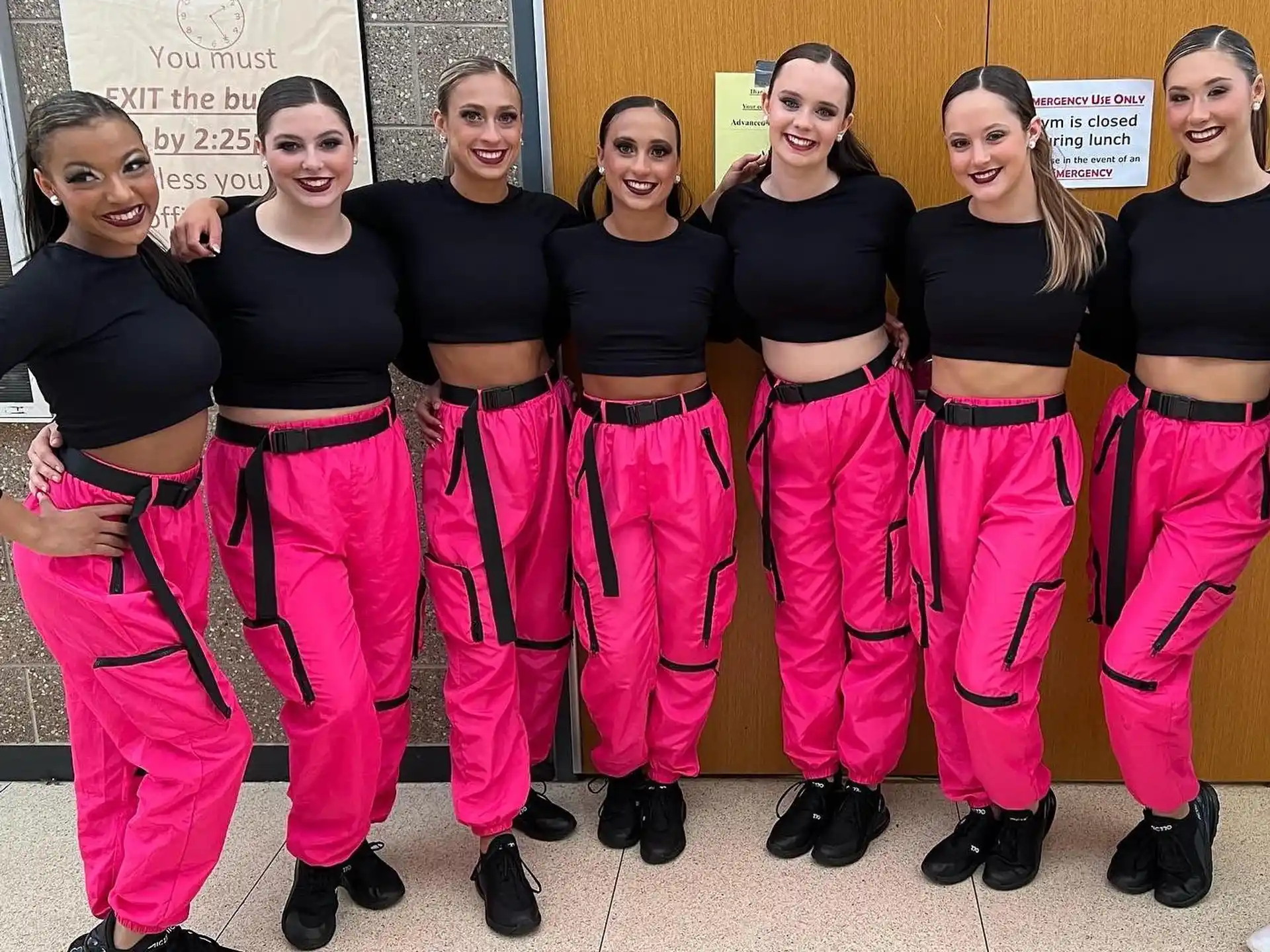 a group of women wearing pink pants