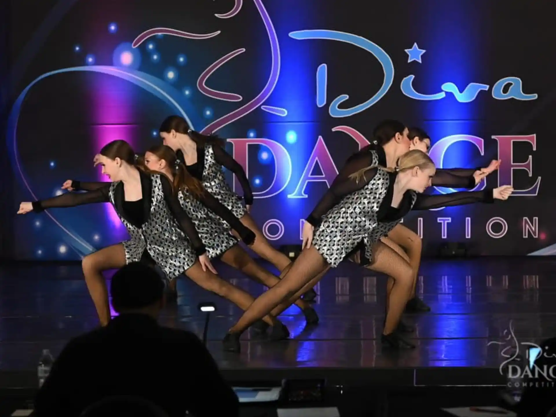 a group of people dancing on a stage