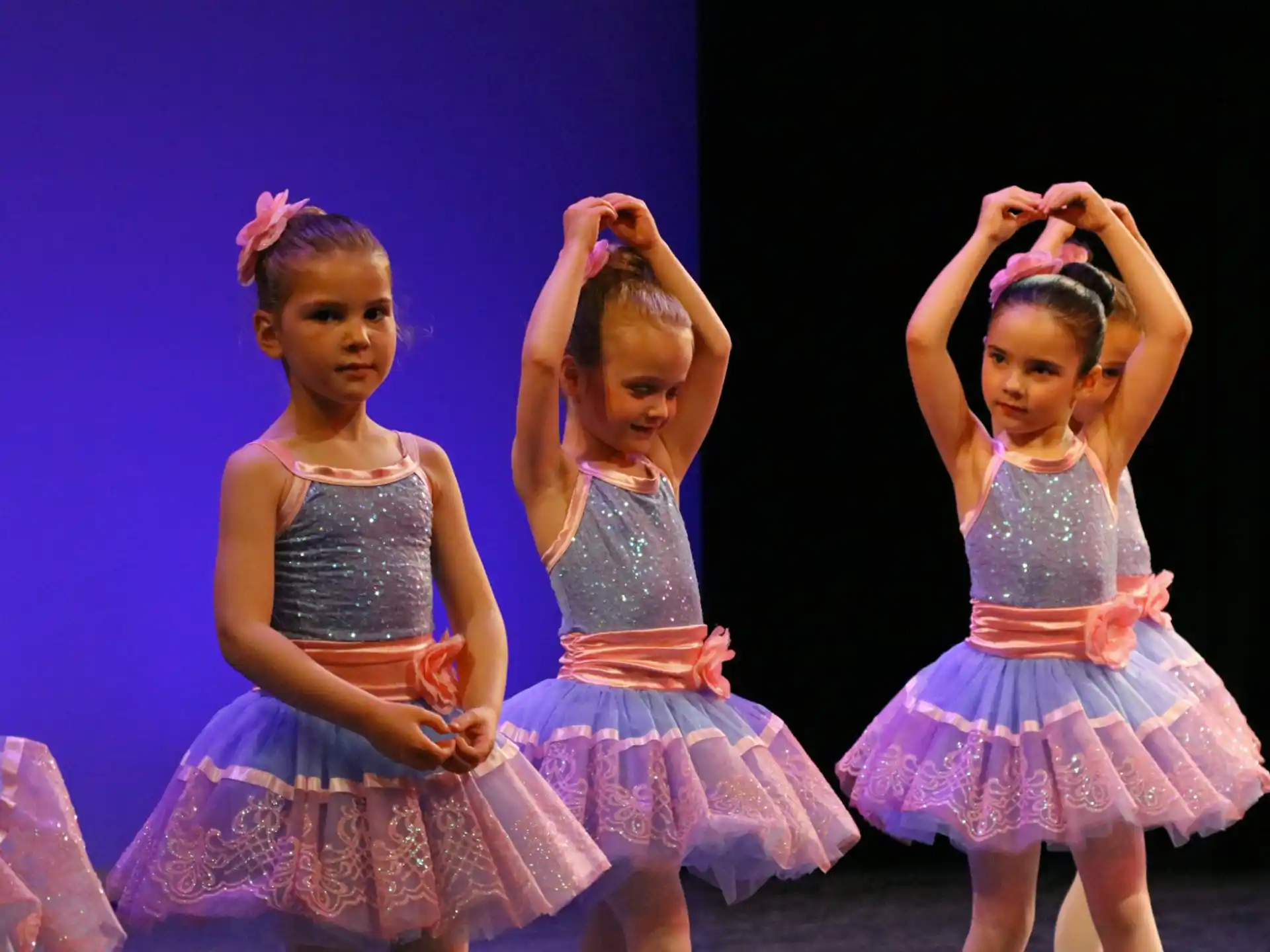 a group of girls in dresses