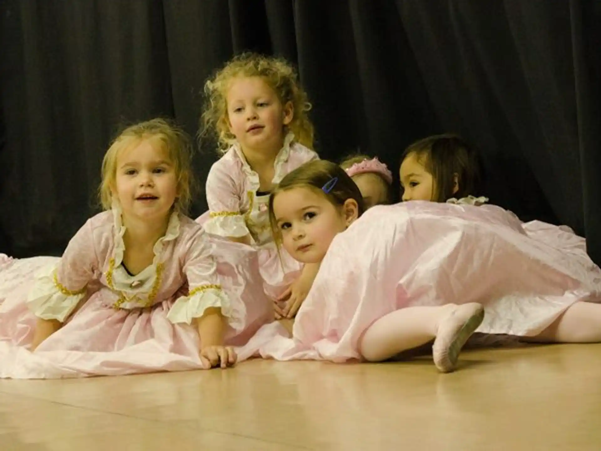 a group of girls in dresses