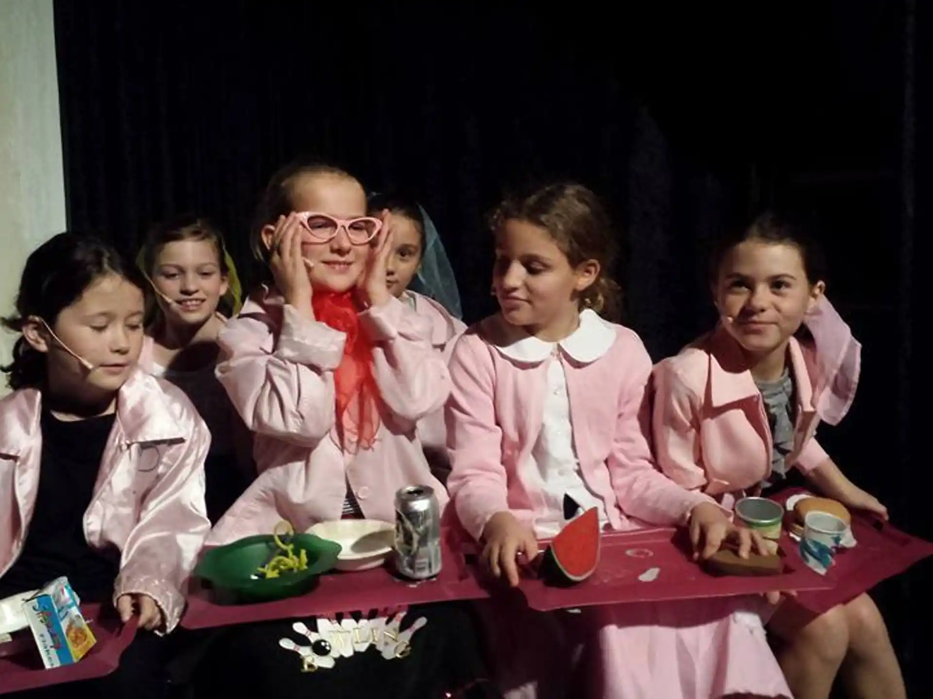 a group of girls sitting at a table