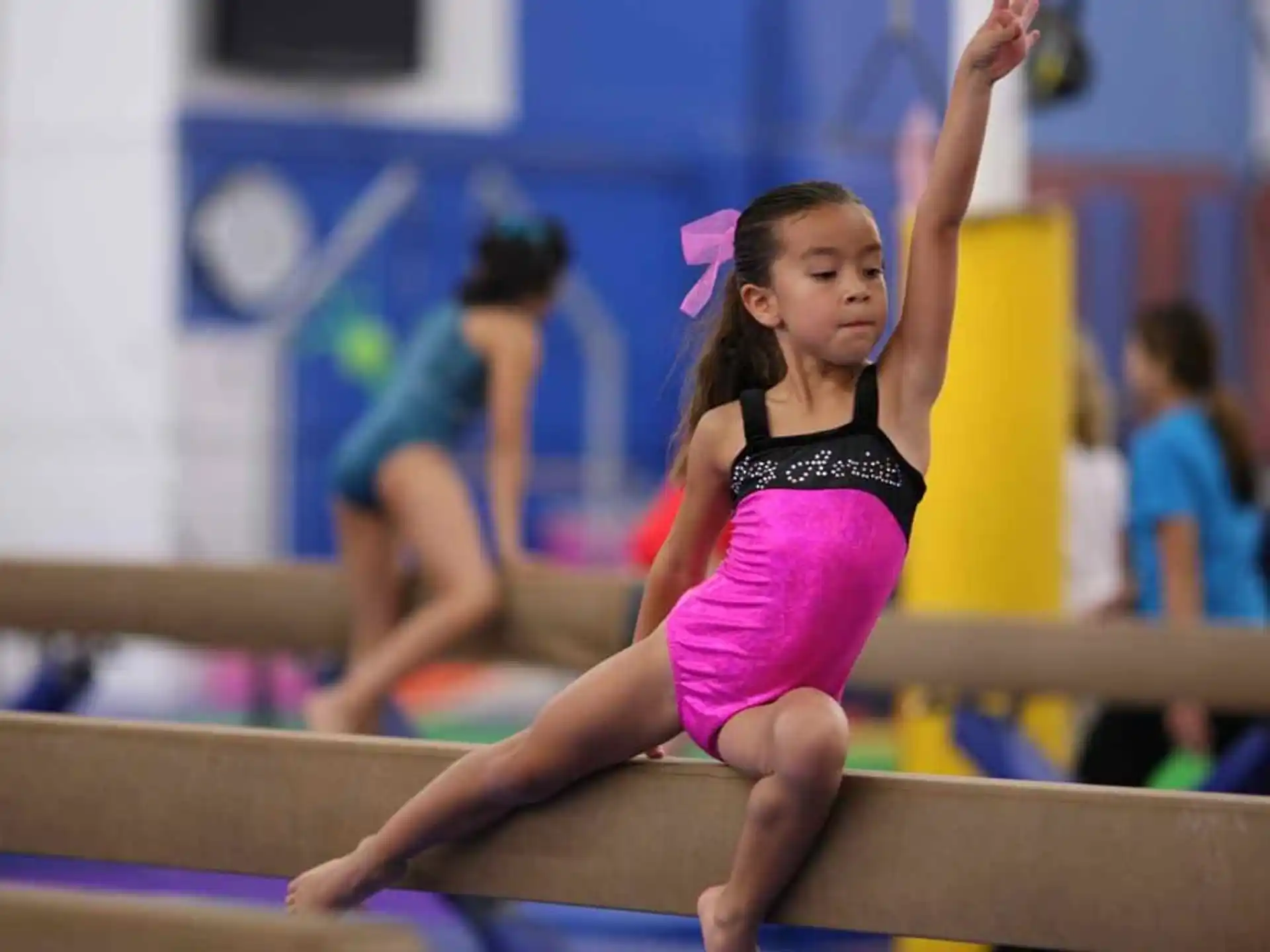 a girl in a leotard doing gymnastics