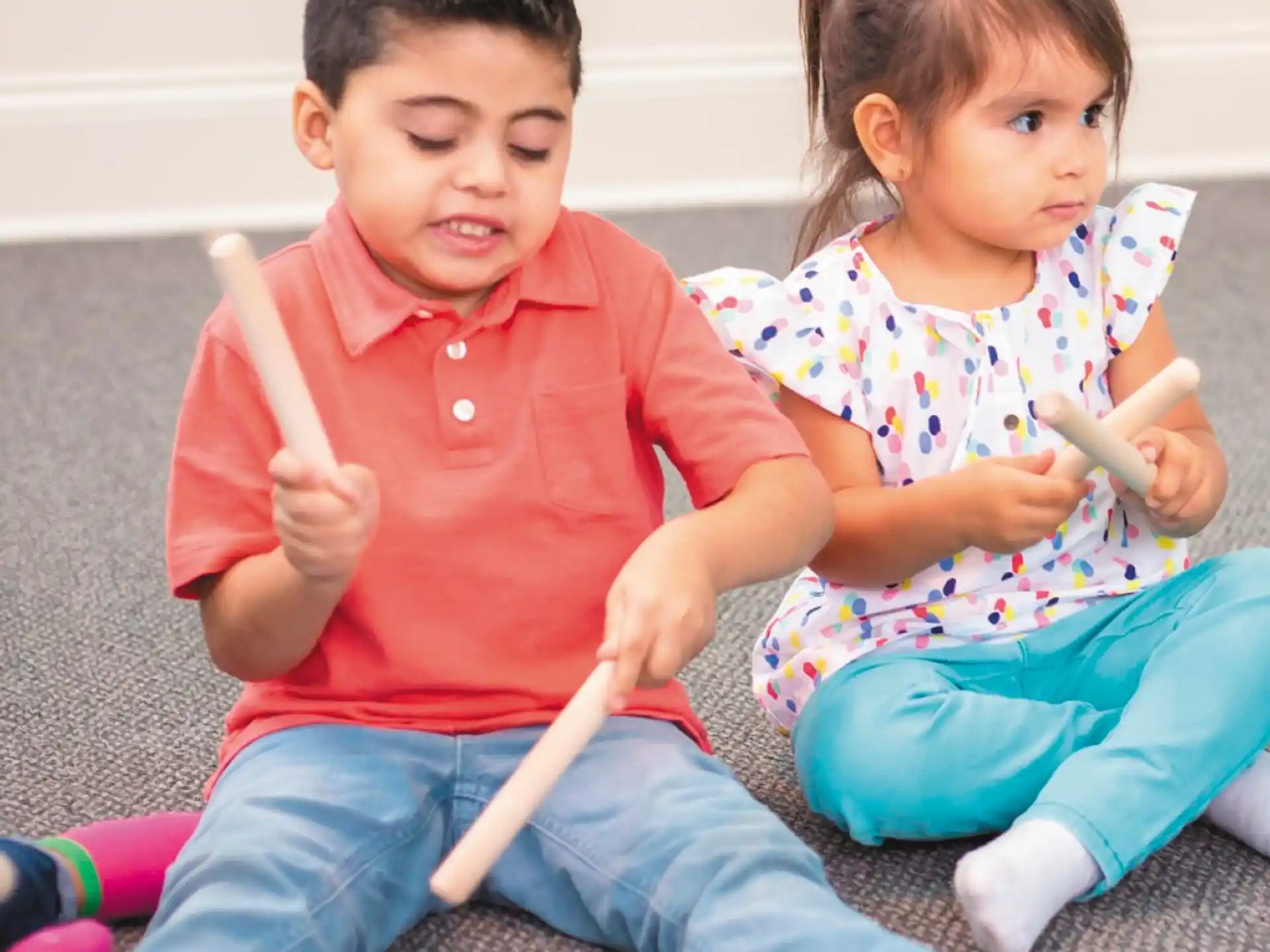 a boy and a girl sitting on the floor