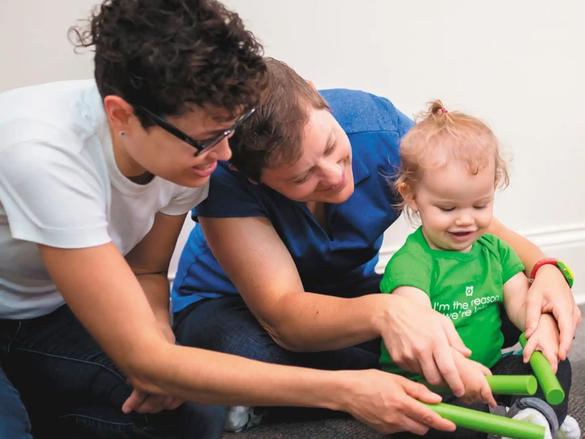 a person and a child playing with a toy