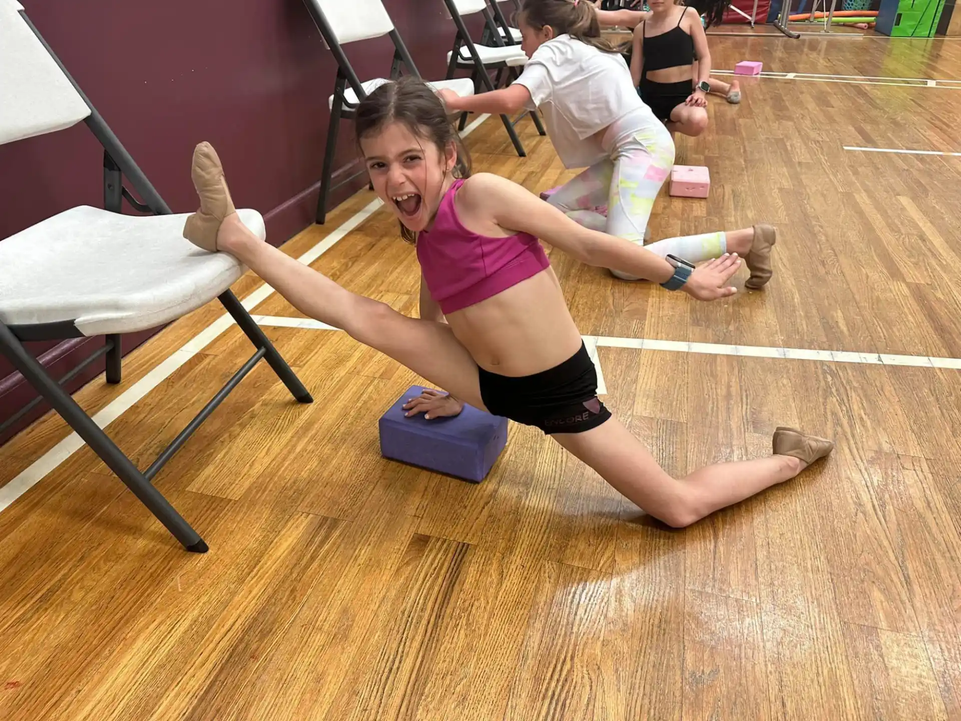 a woman doing yoga on a wood floor