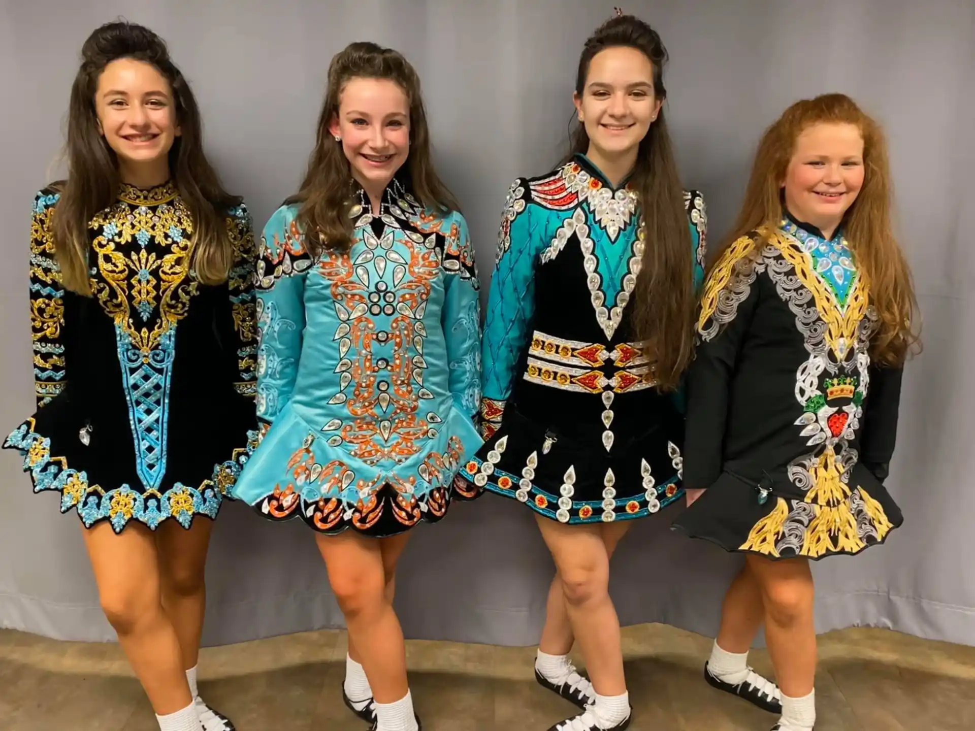 a group of girls in dresses