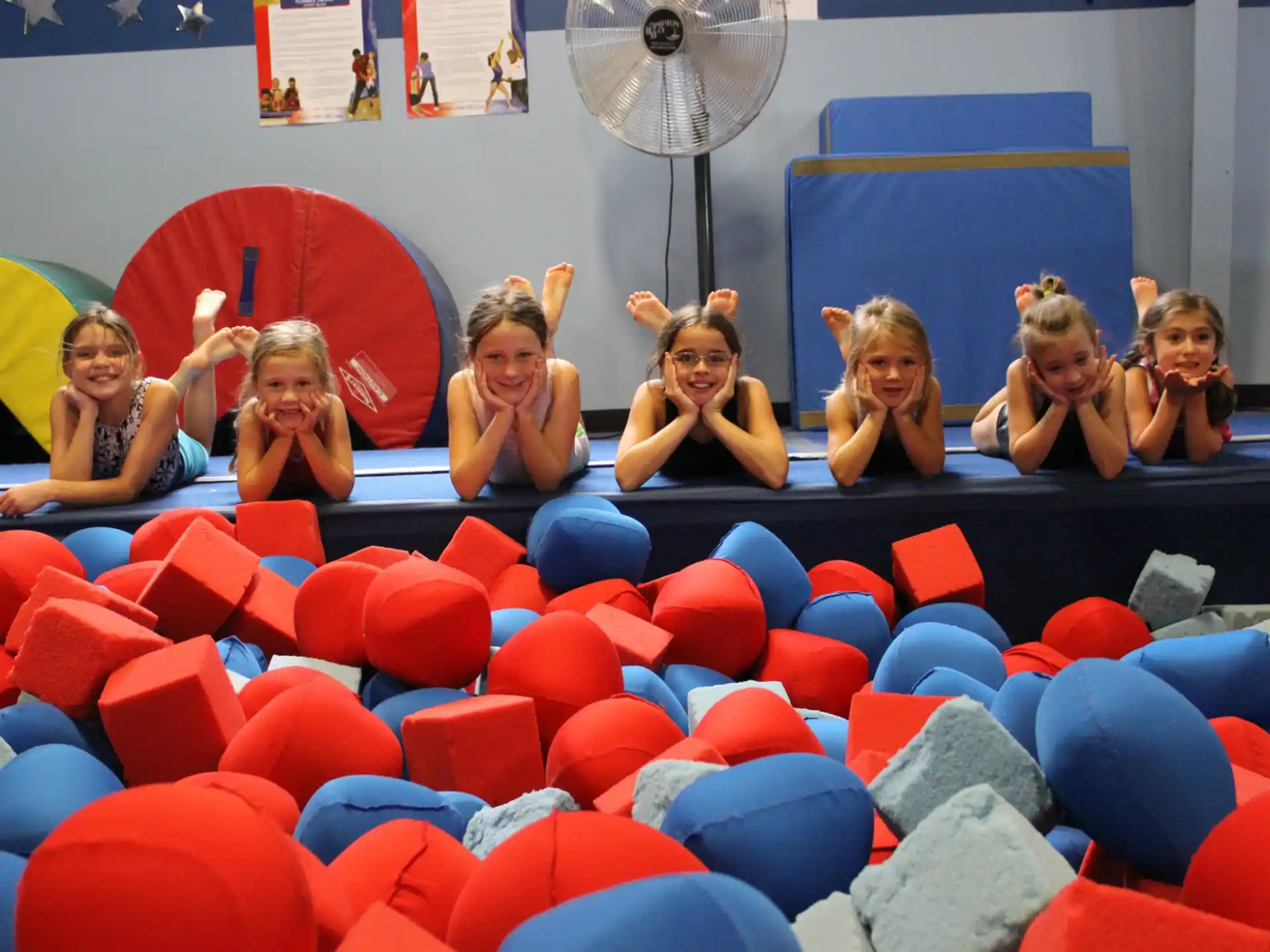 a group of women sitting in a large ball pit