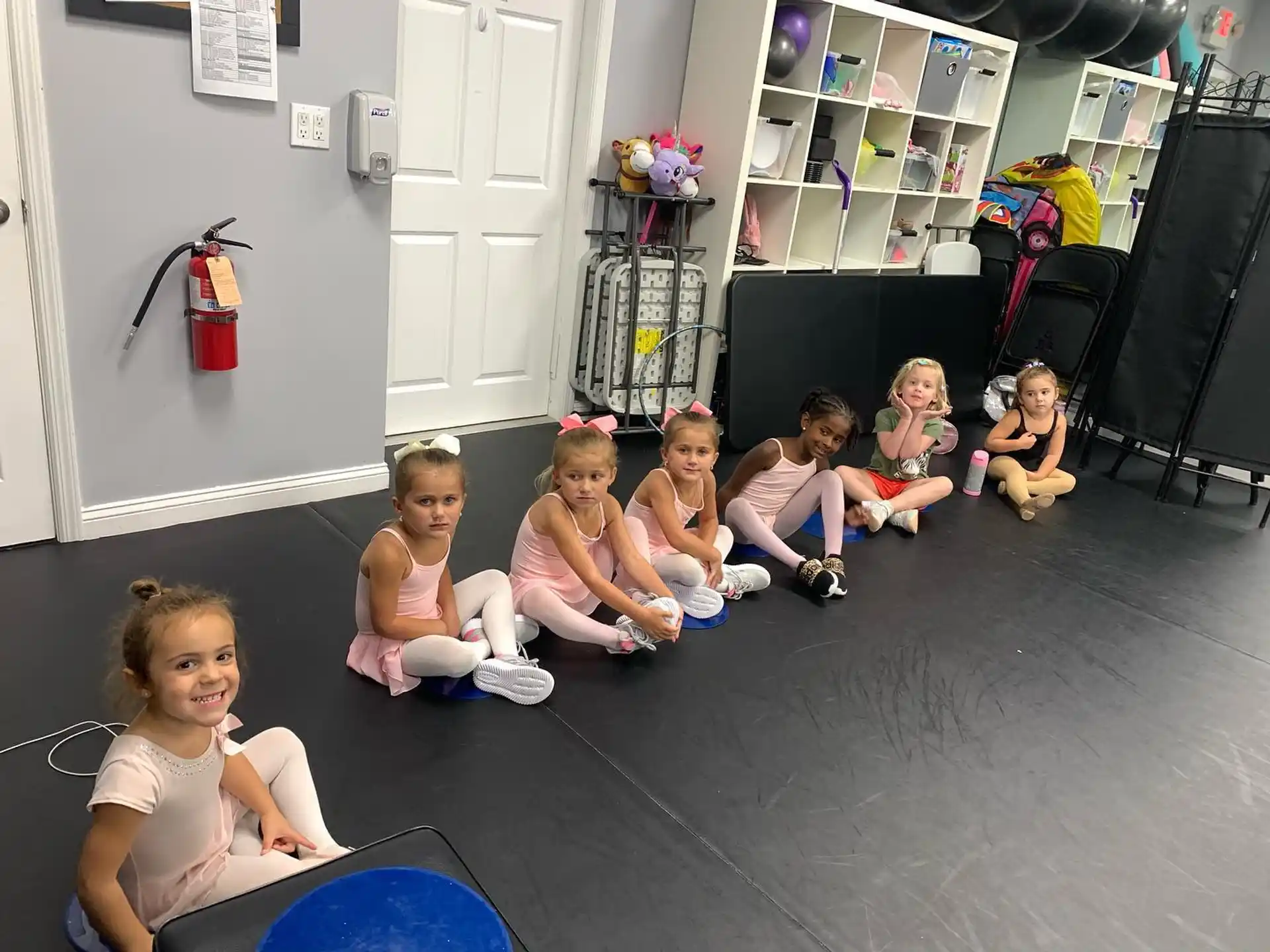 a group of children sitting on the floor in a room