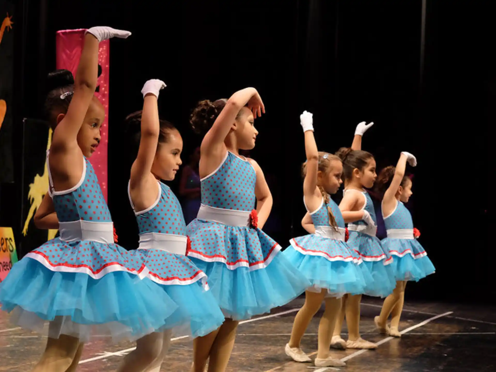 a group of girls performing on stage