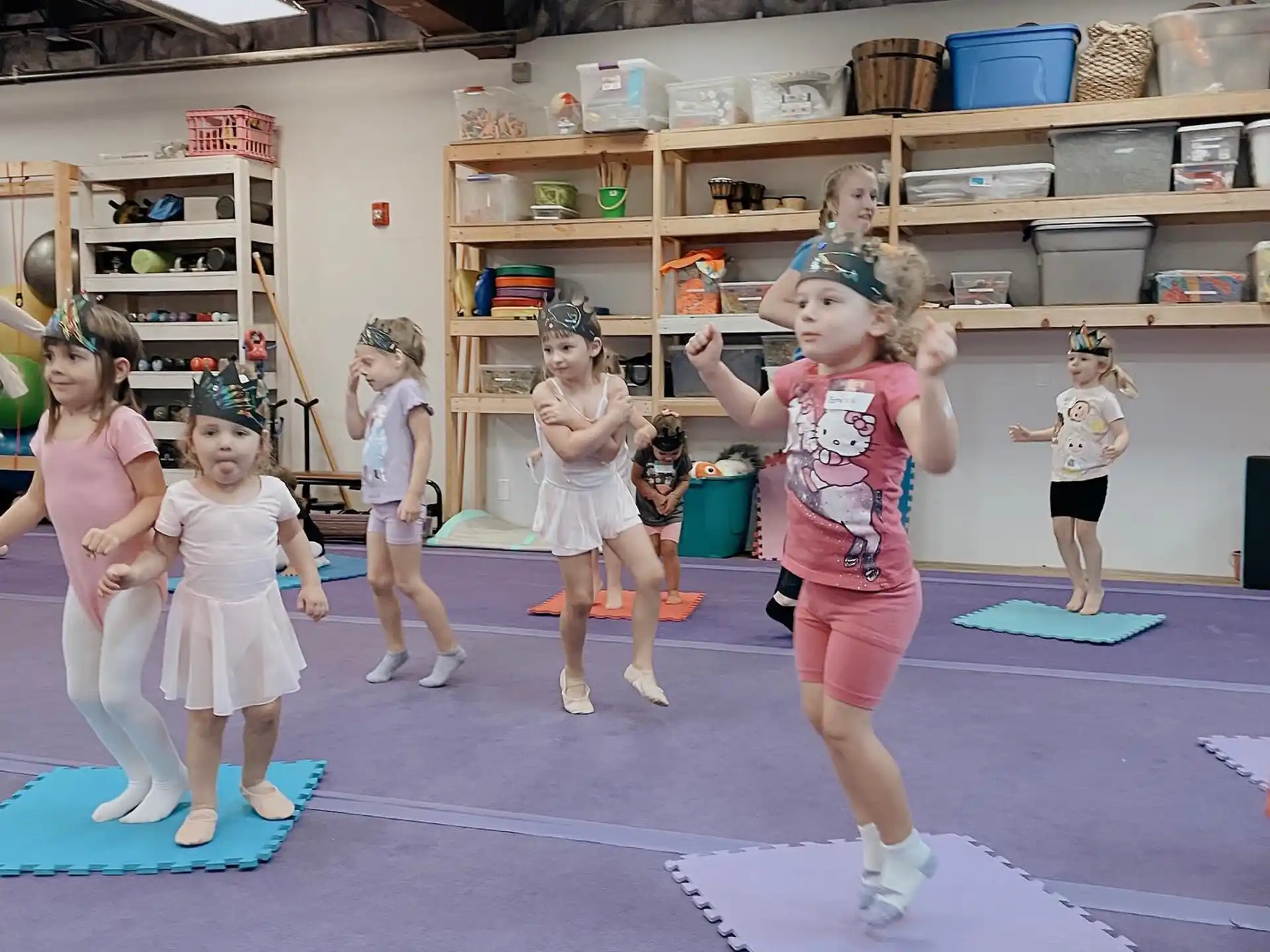 a group of children exercising in a gym