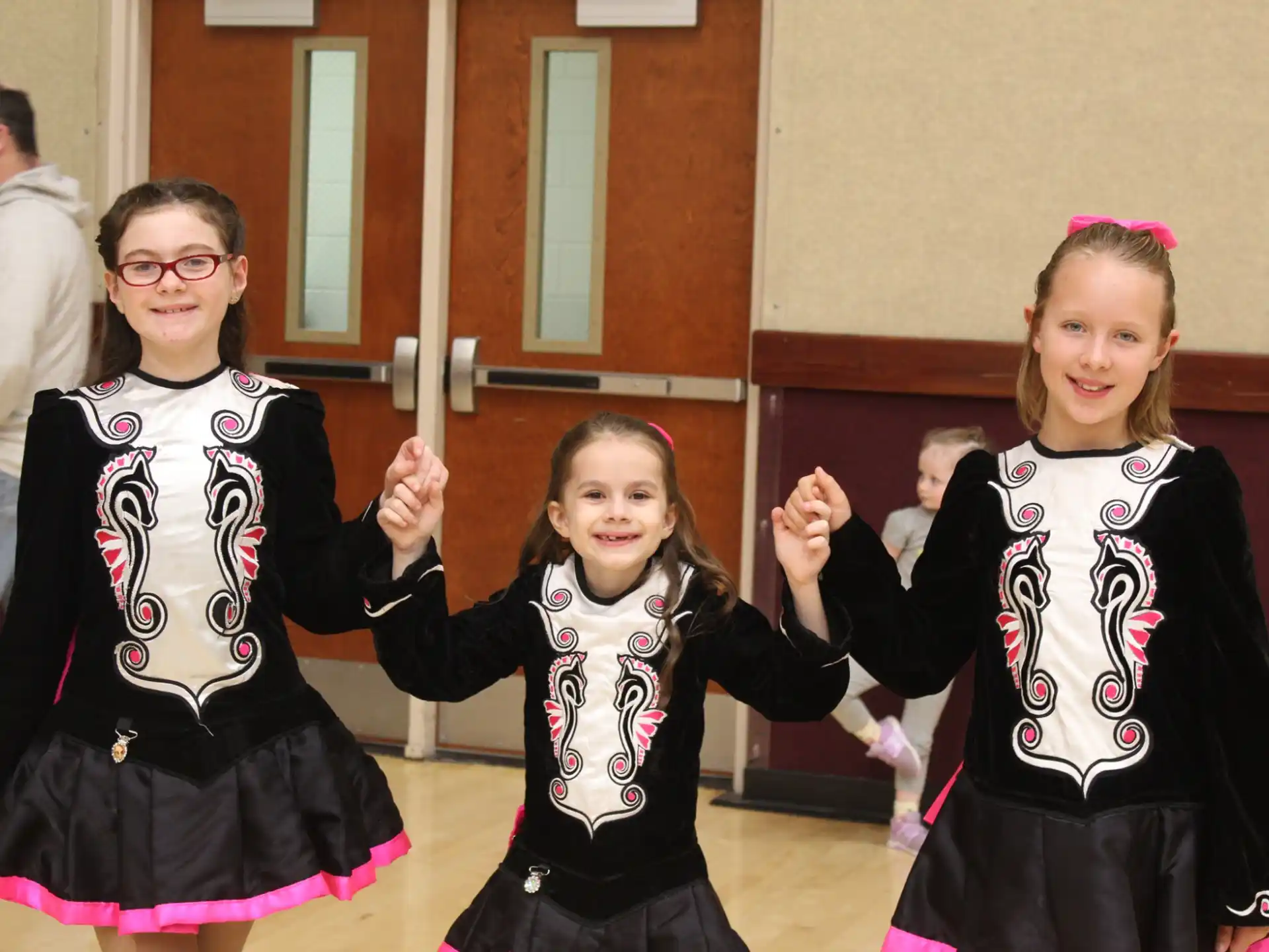 a group of girls in black and white dresses