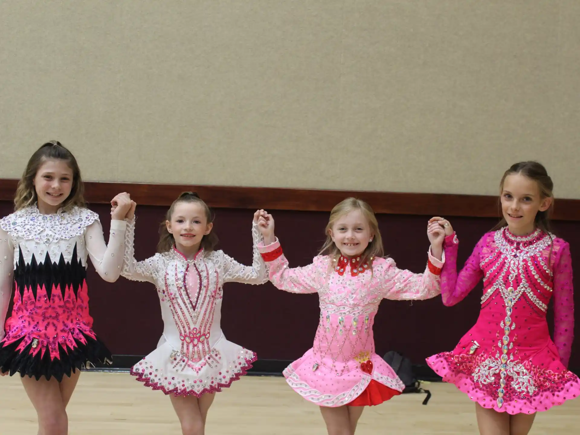 a group of girls in dresses