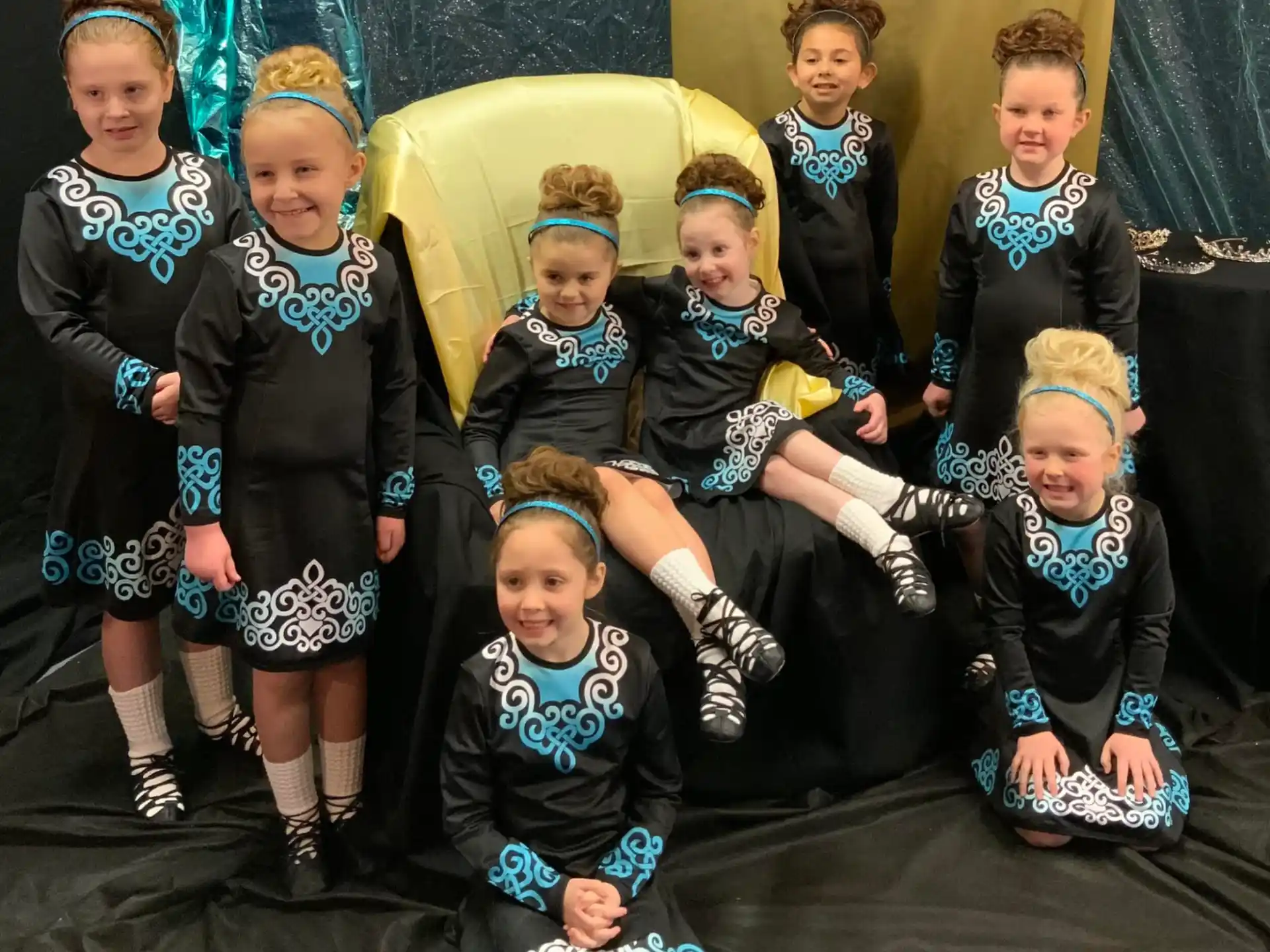 a group of children in black and white uniforms