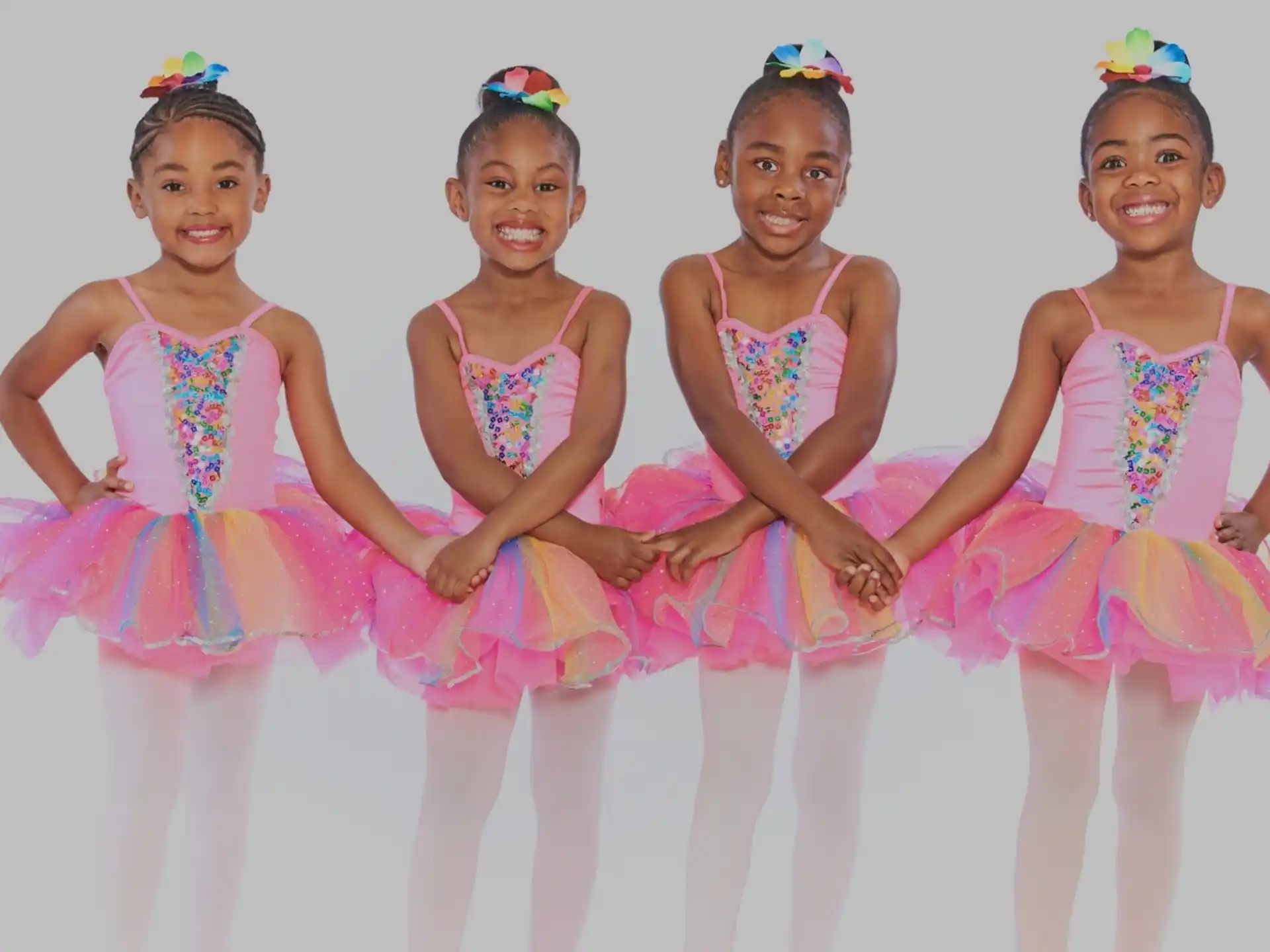 a group of girls in pink dresses