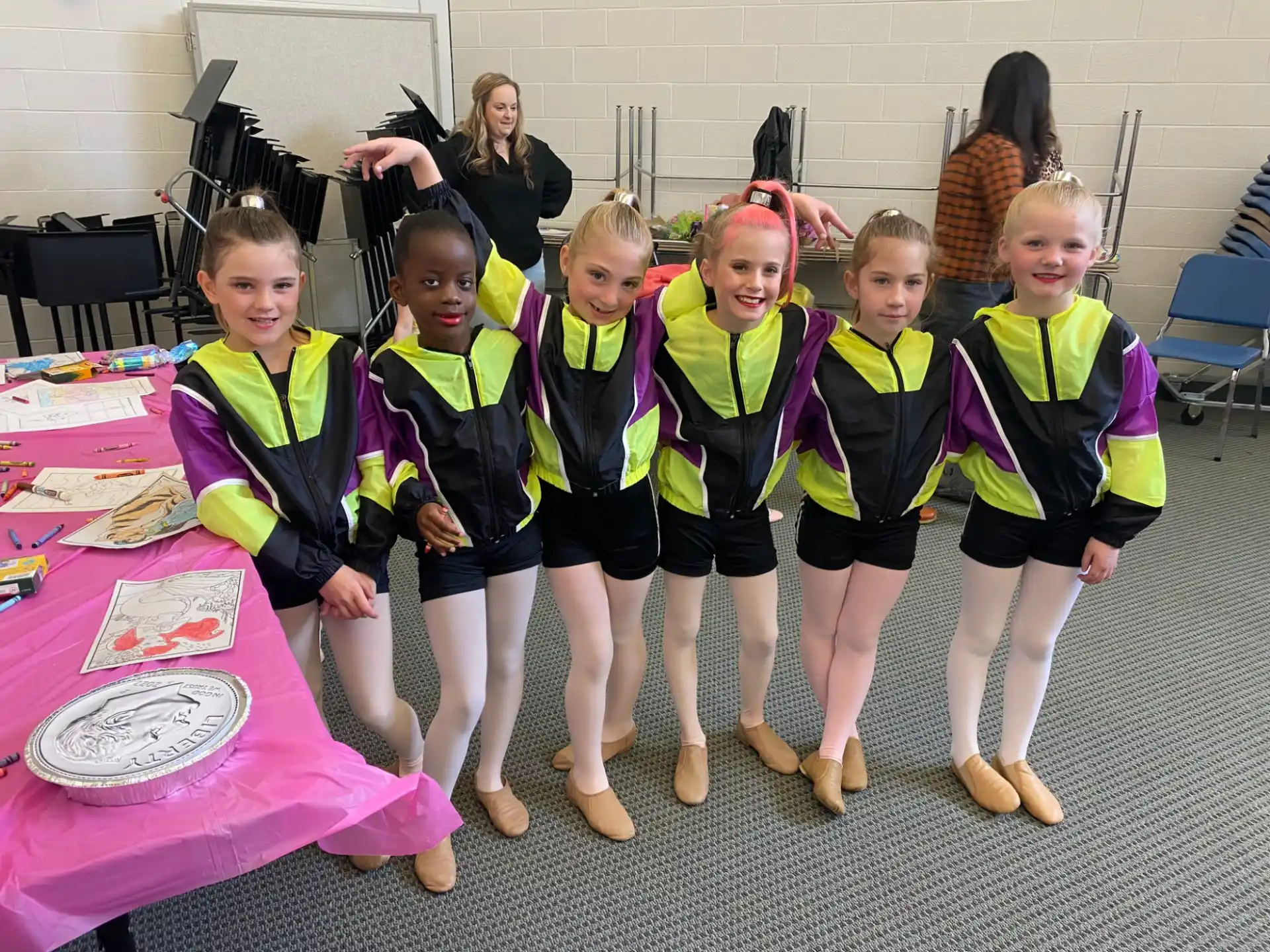 a group of girls in matching vests