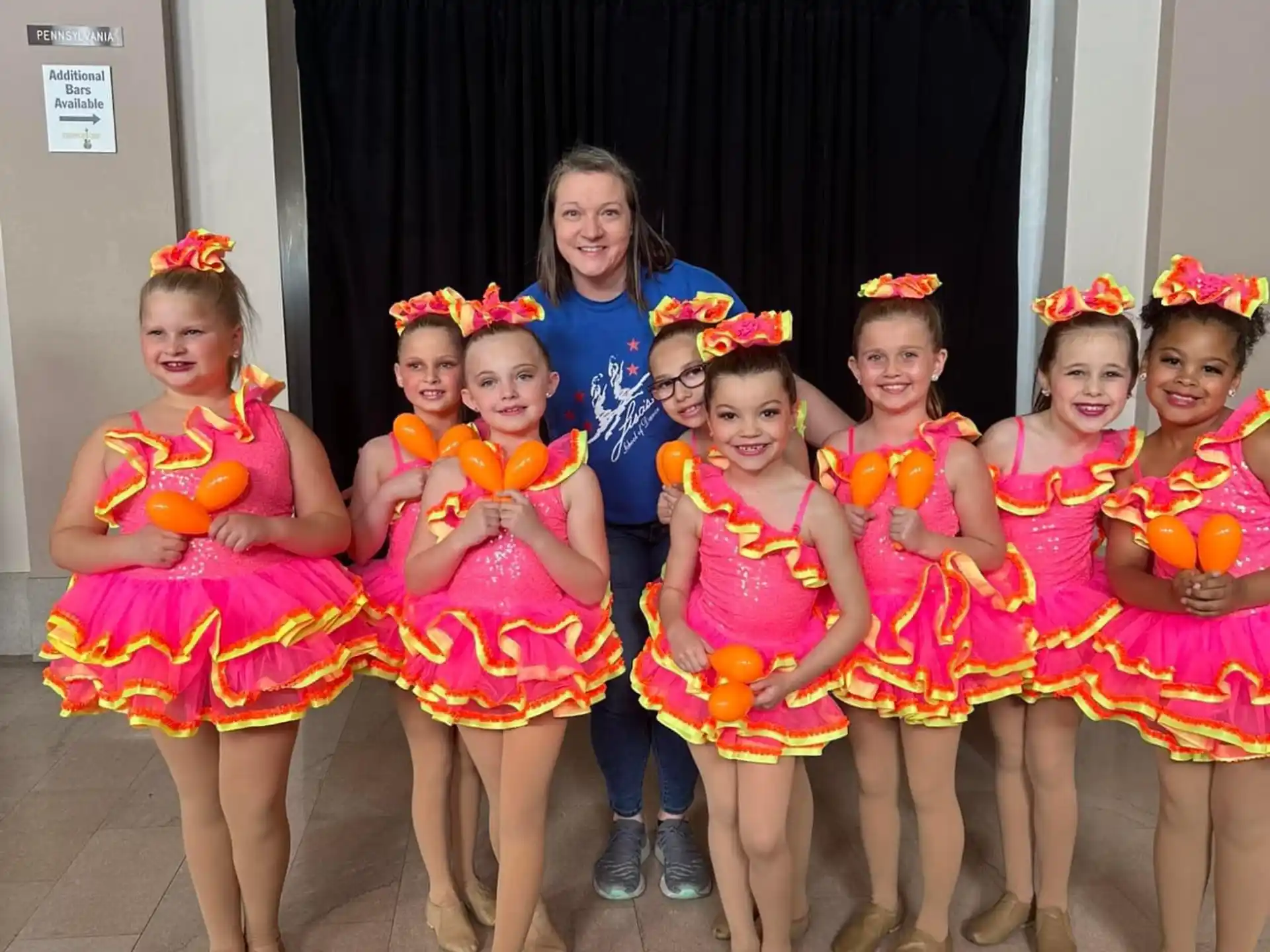 a group of girls in colorful dresses