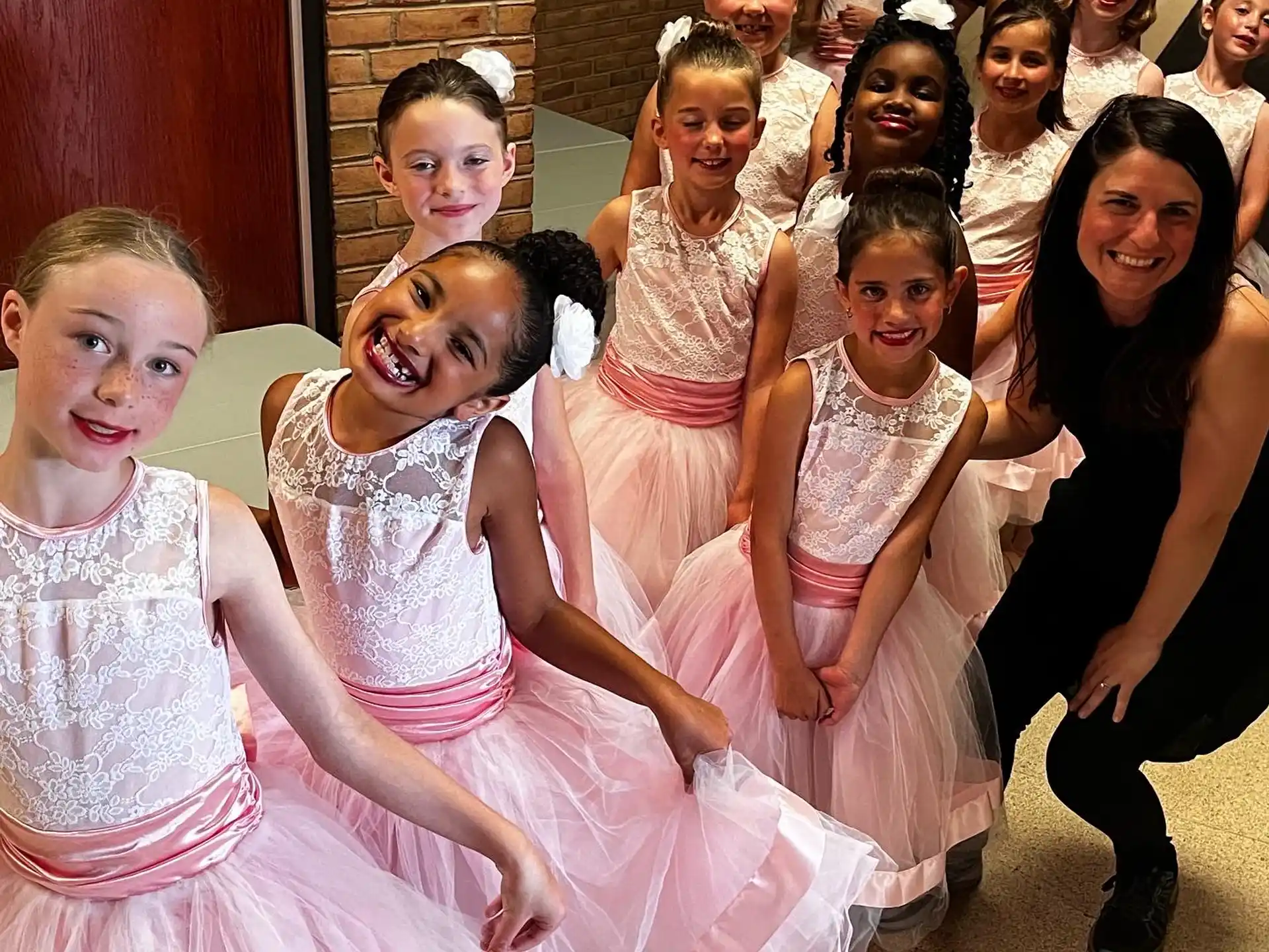 a group of girls in dresses