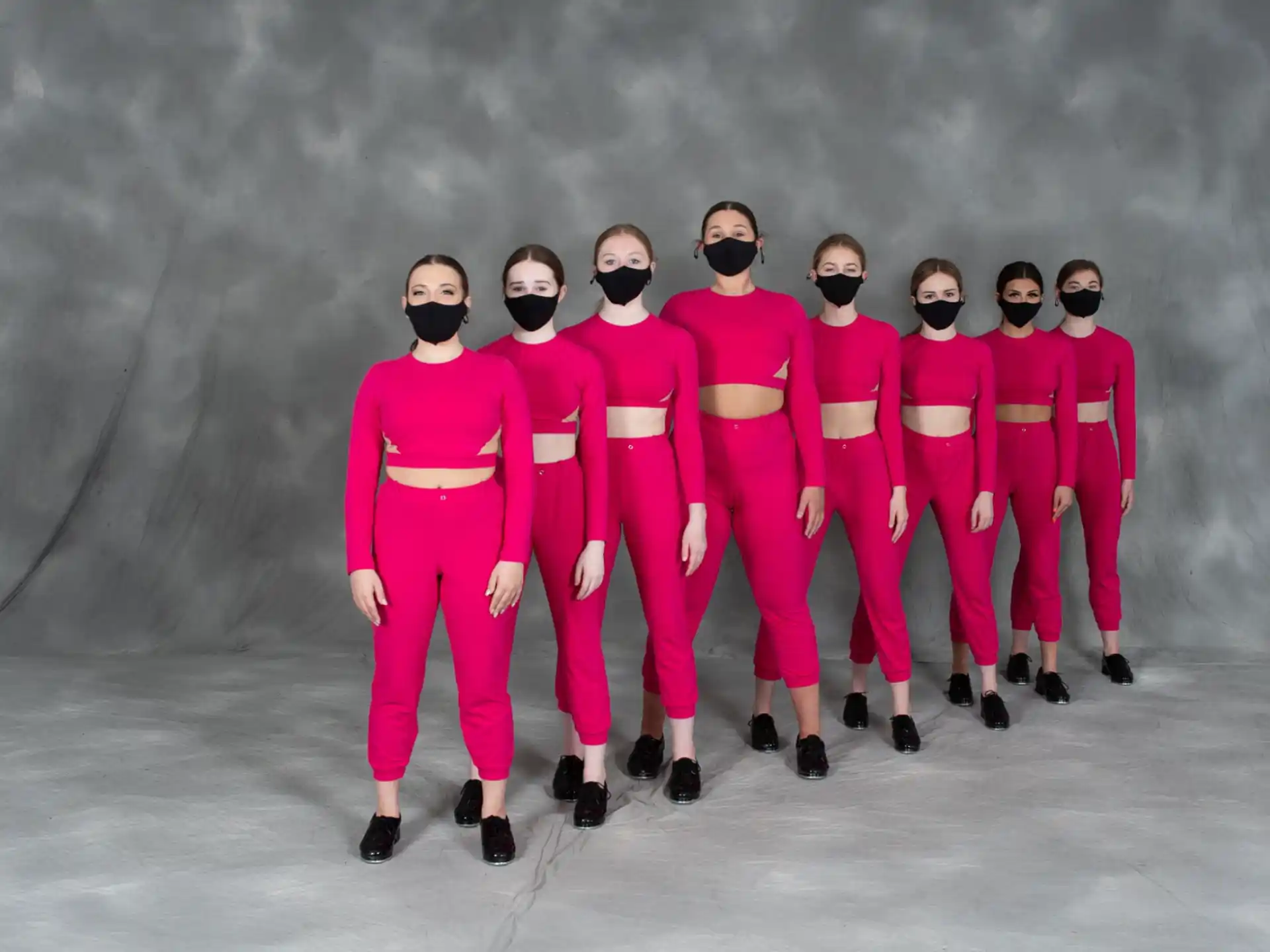 a group of men in pink suits