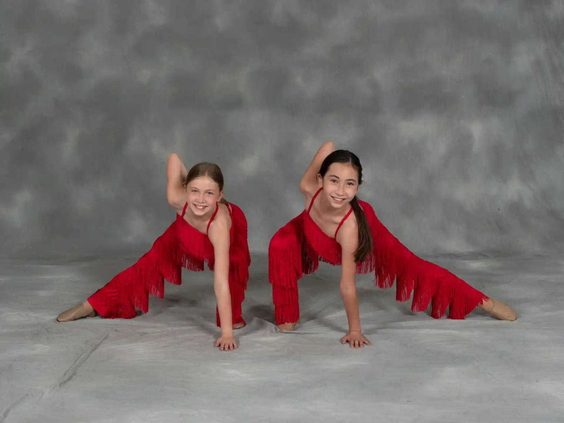 two women in red dresses