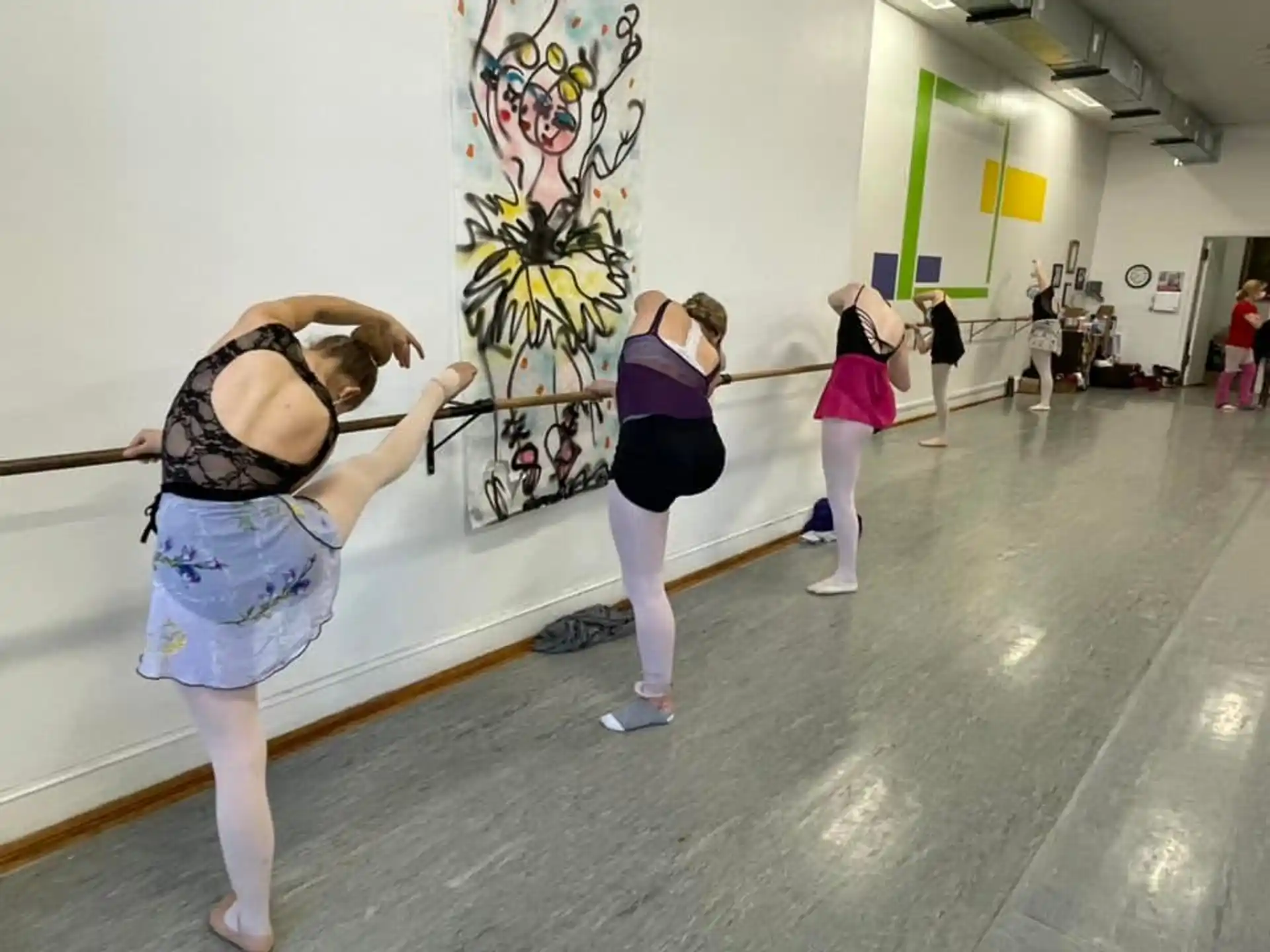a group of people exercising in a gym