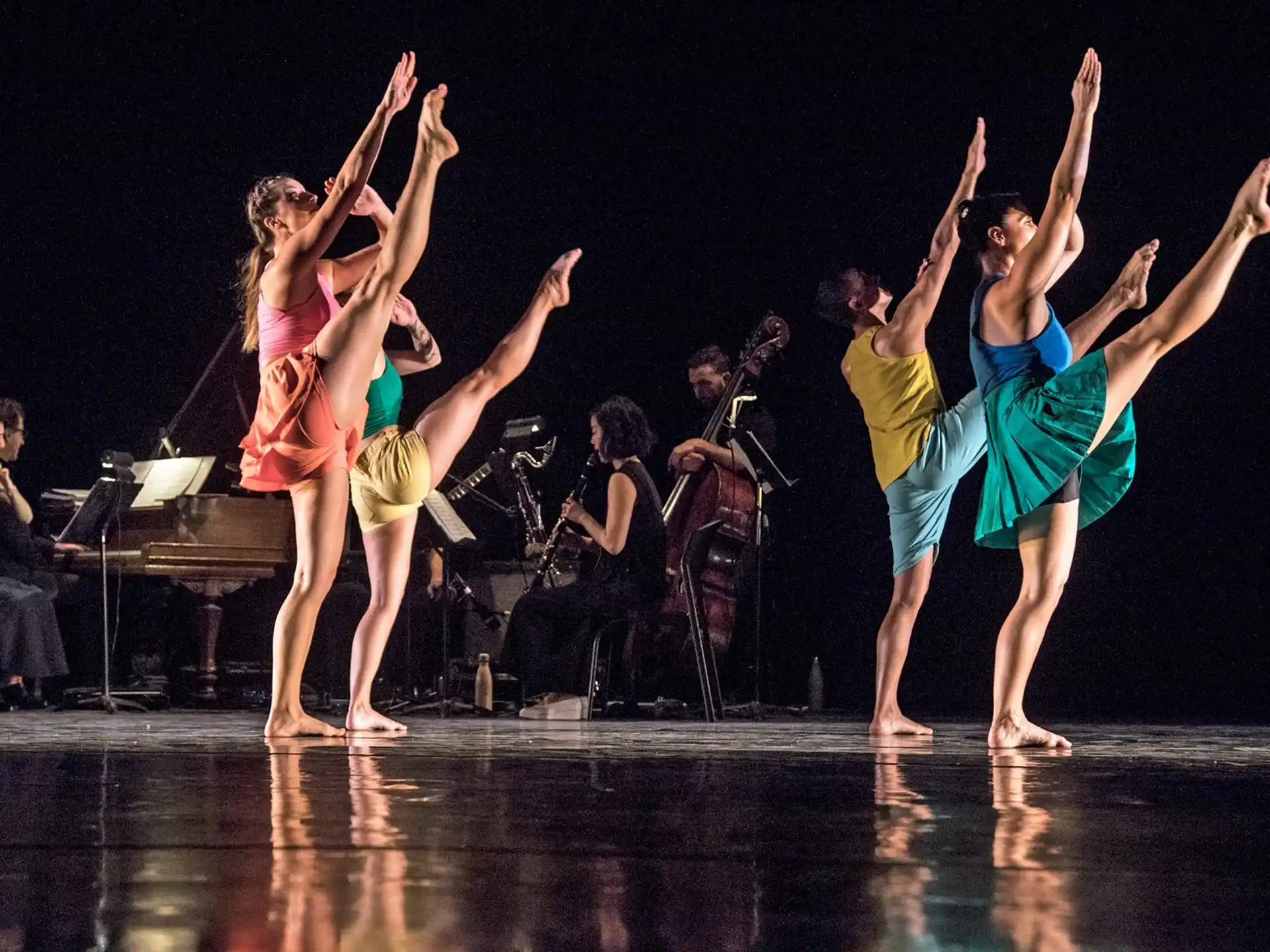 a group of people dancing on a stage