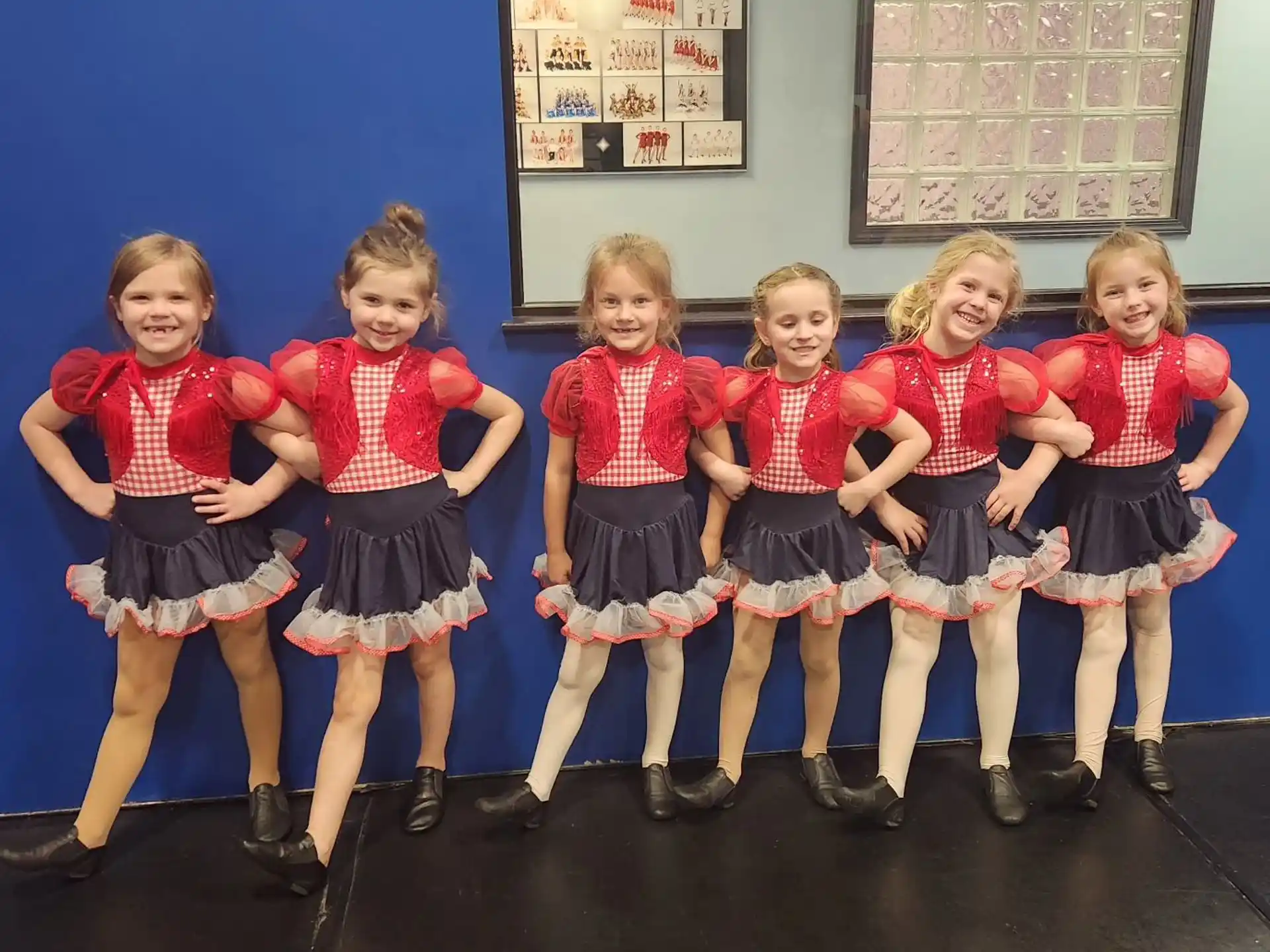 a group of girls in matching outfits